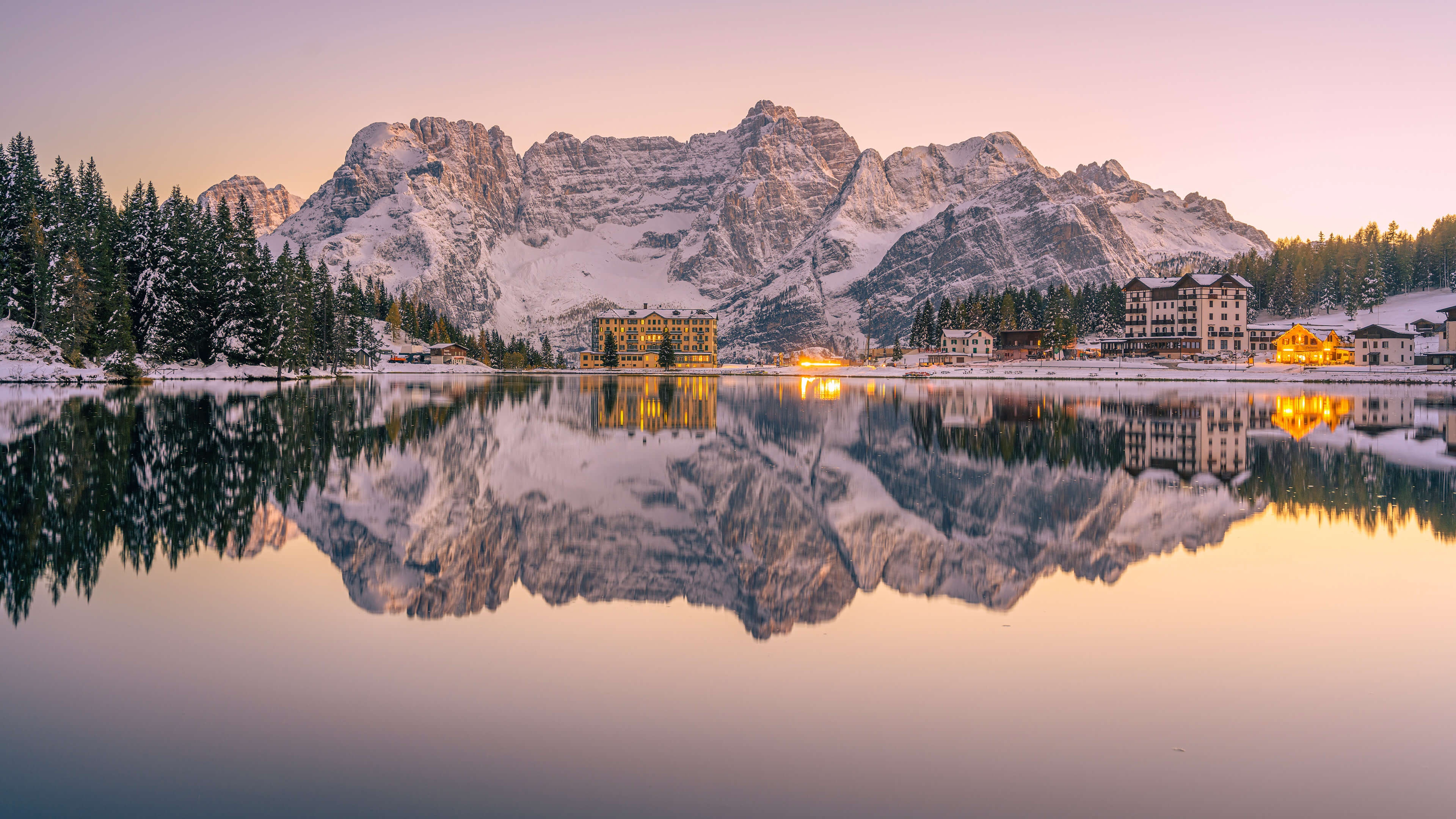 Lake Misurina with snow-capped mountains and hotels HD Wallpaper