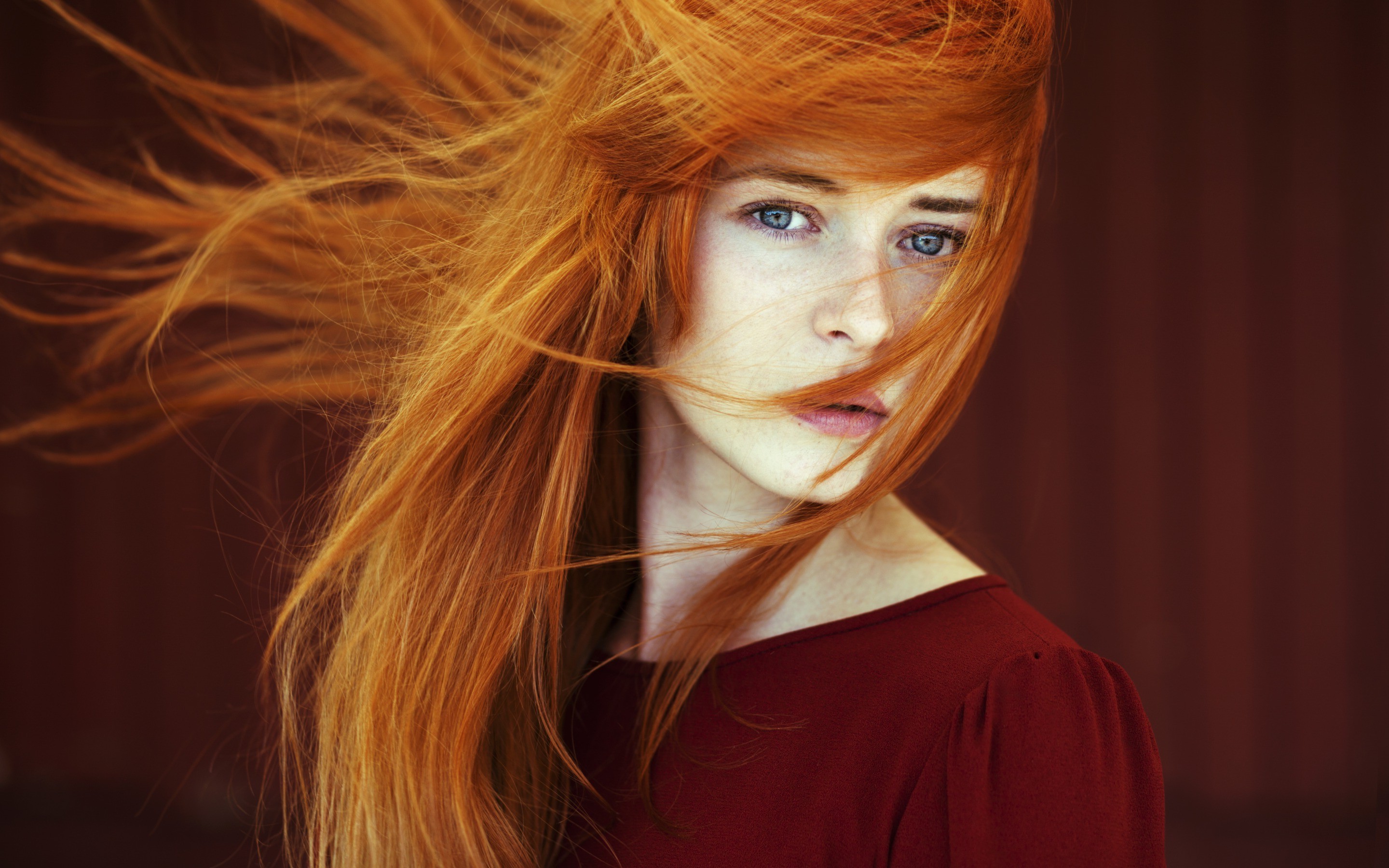 Redhead woman with blue eyes and windblown hair HD Wallpaper