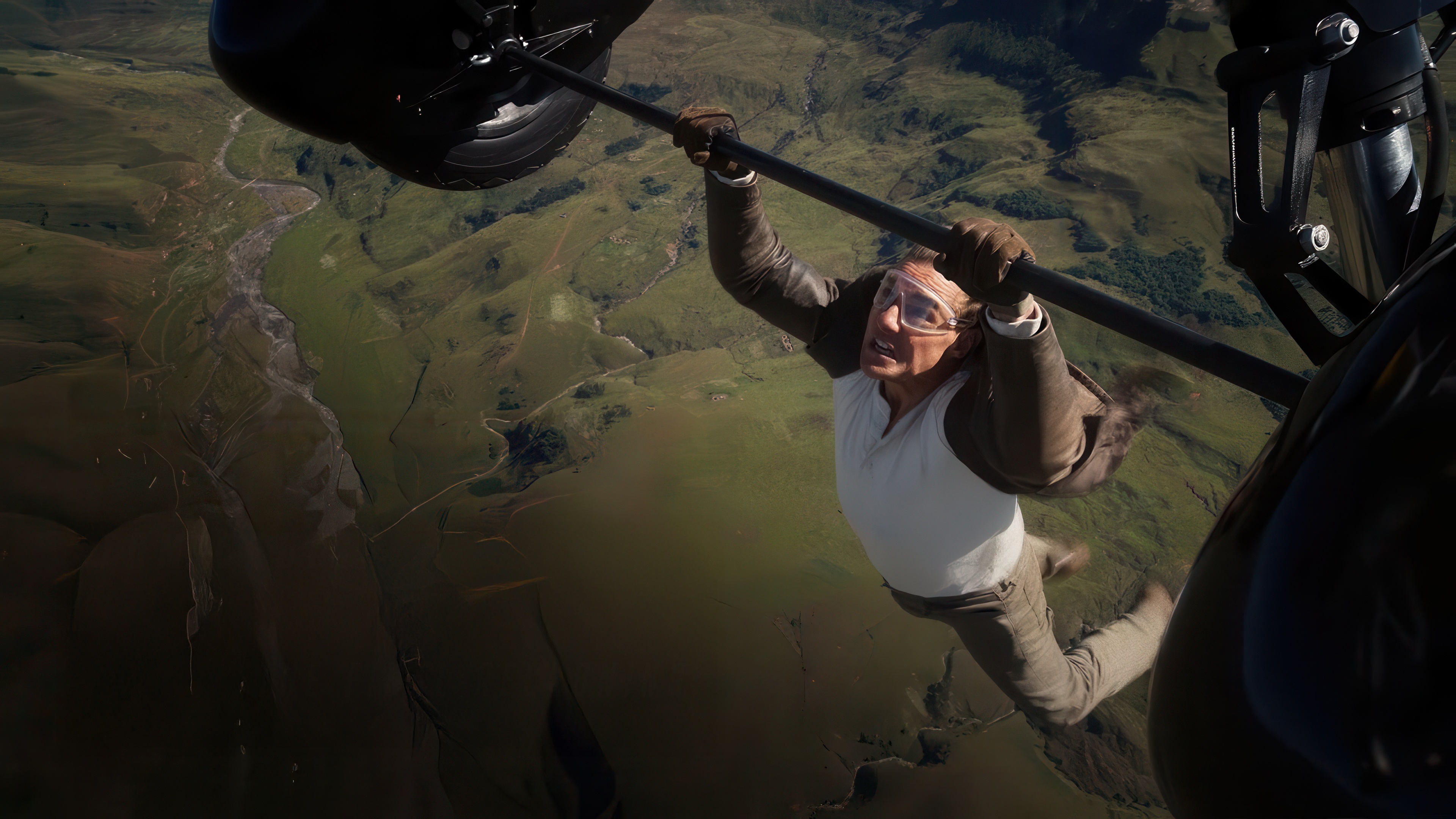 Tom Cruise hanging from a helicopter in Mission Impossible HD Wallpaper