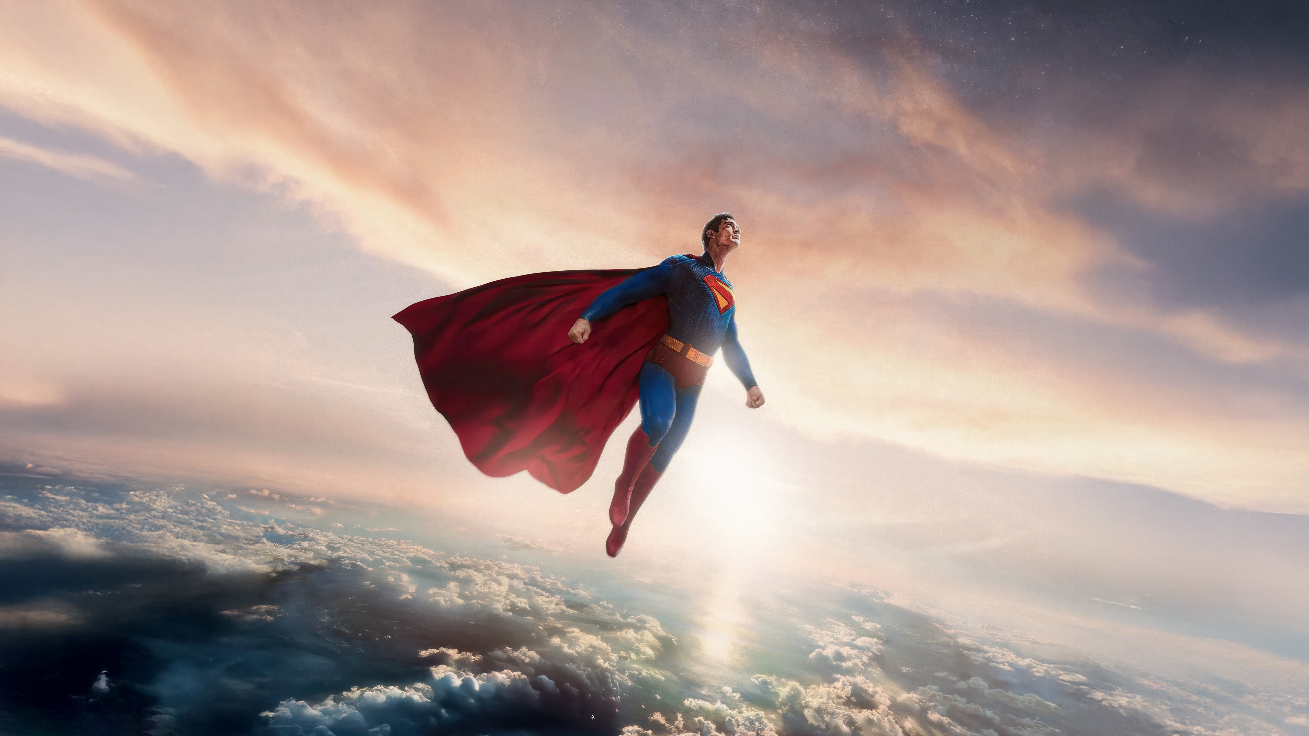 Superman flying over clouds at sunset HD Wallpaper