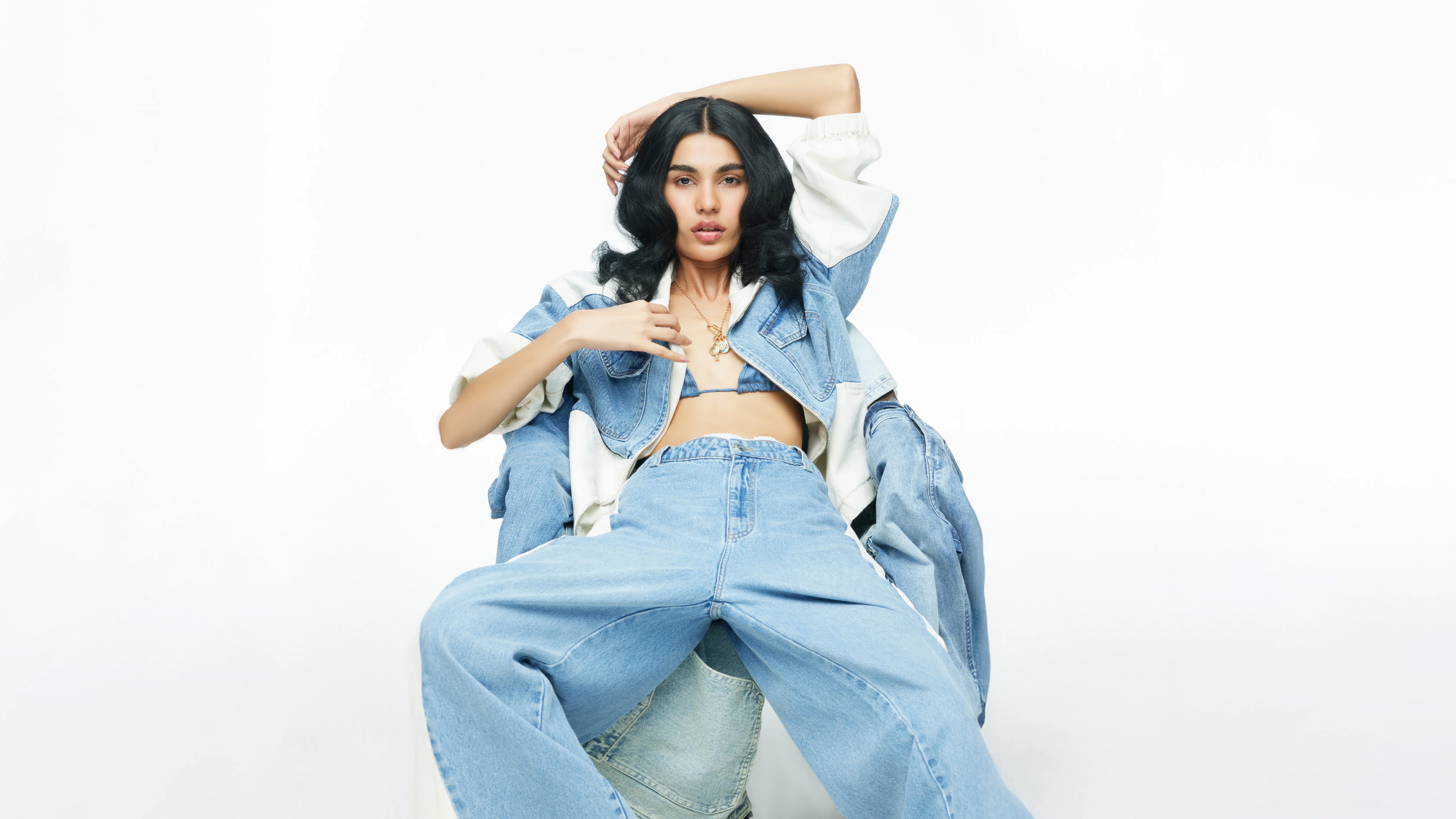 Woman in denim outfit sitting on chairs HD Wallpaper