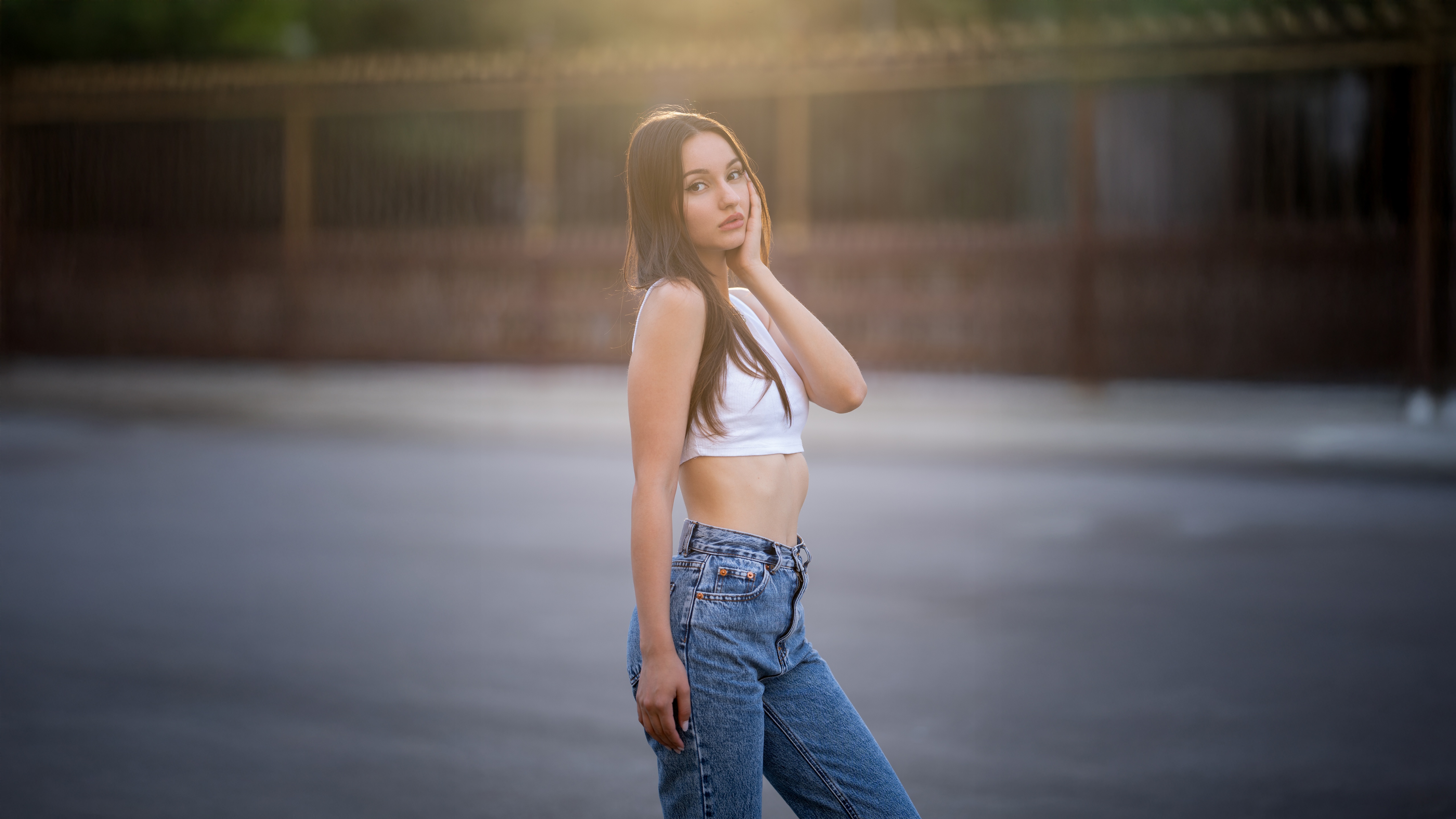Girl in white top and jeans looking at viewer HD Wallpaper