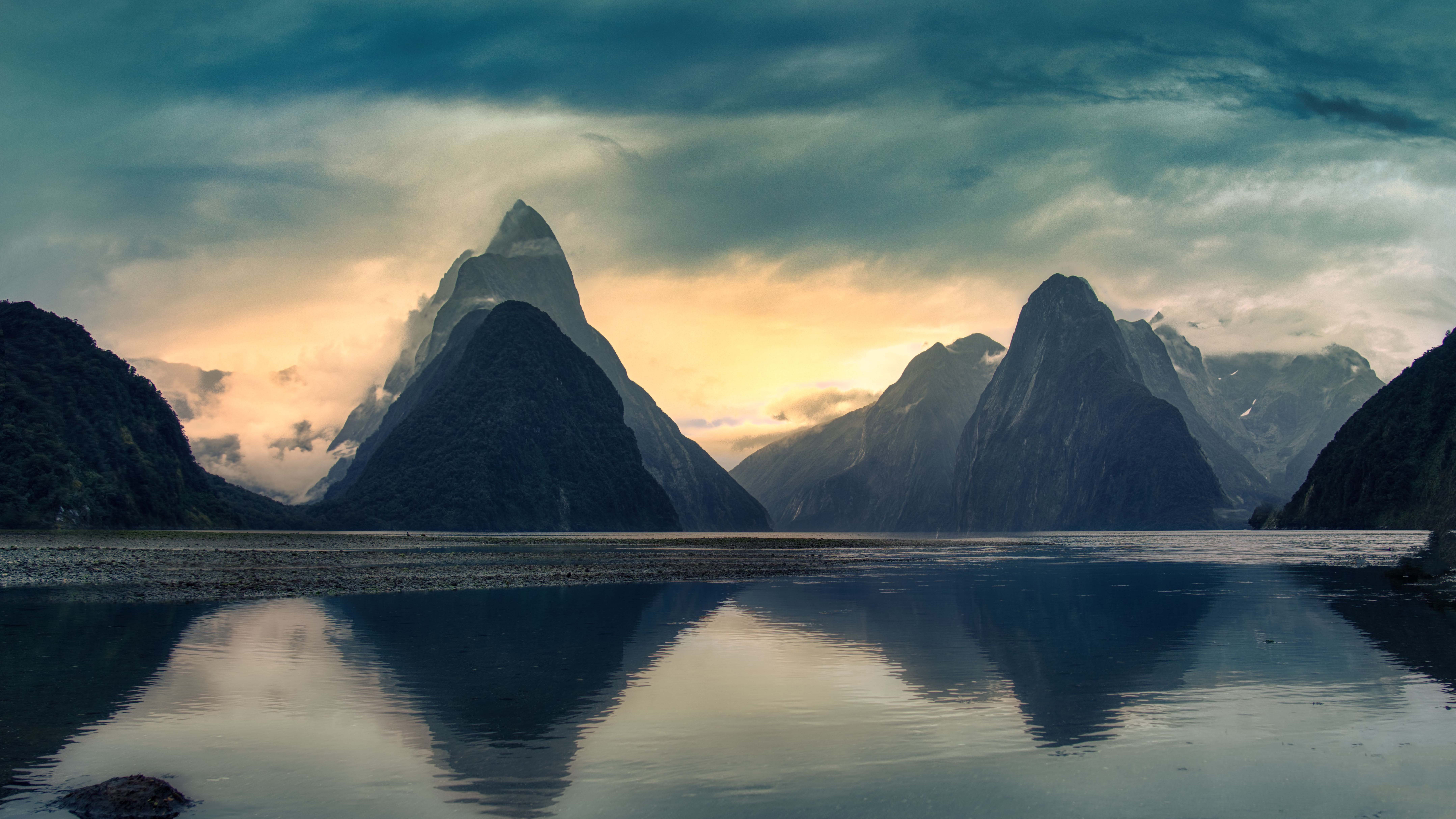 Milford Sound at sunset with dramatic clouds HD Wallpaper