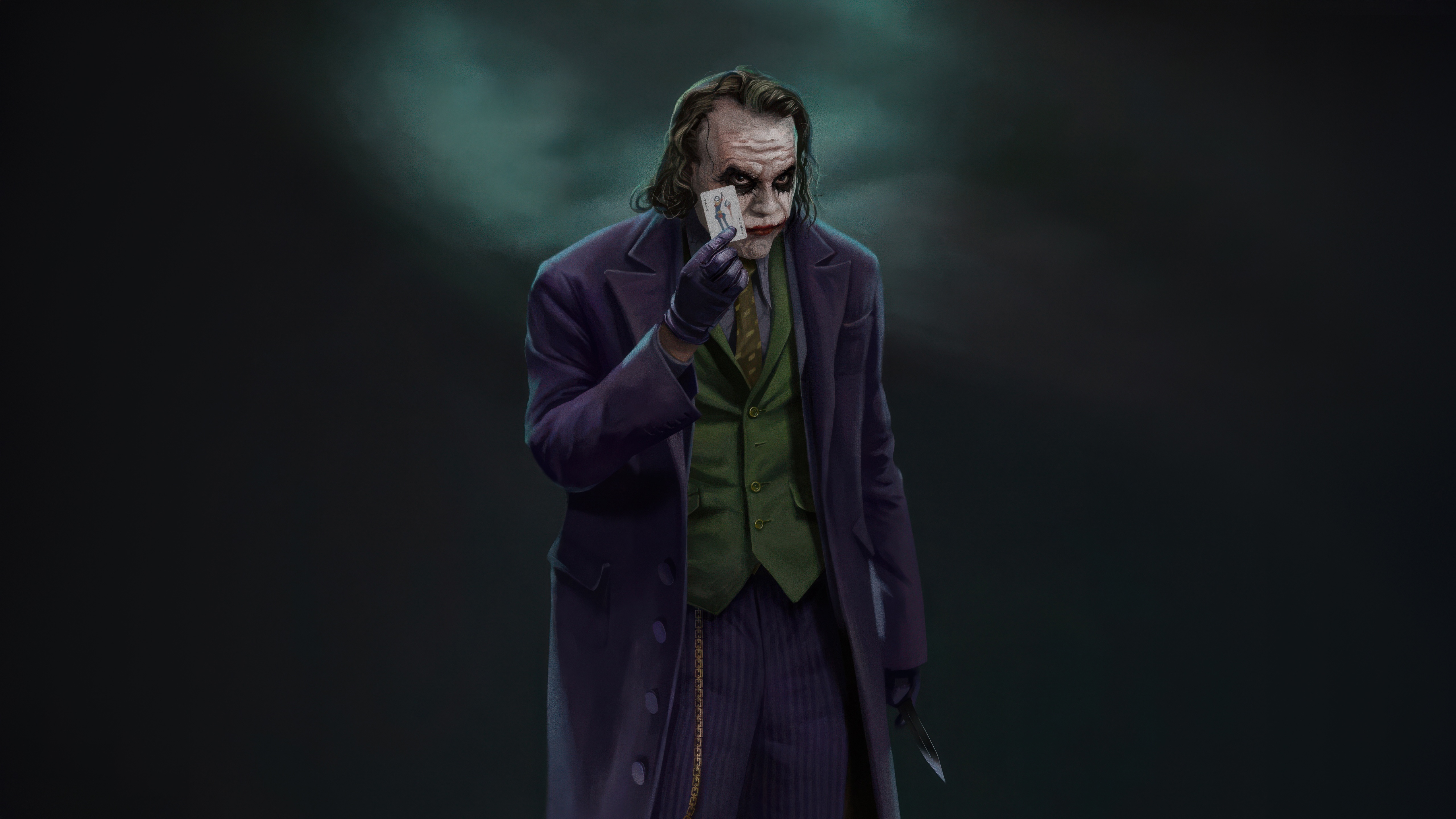 The Joker holding a playing card HD Wallpaper