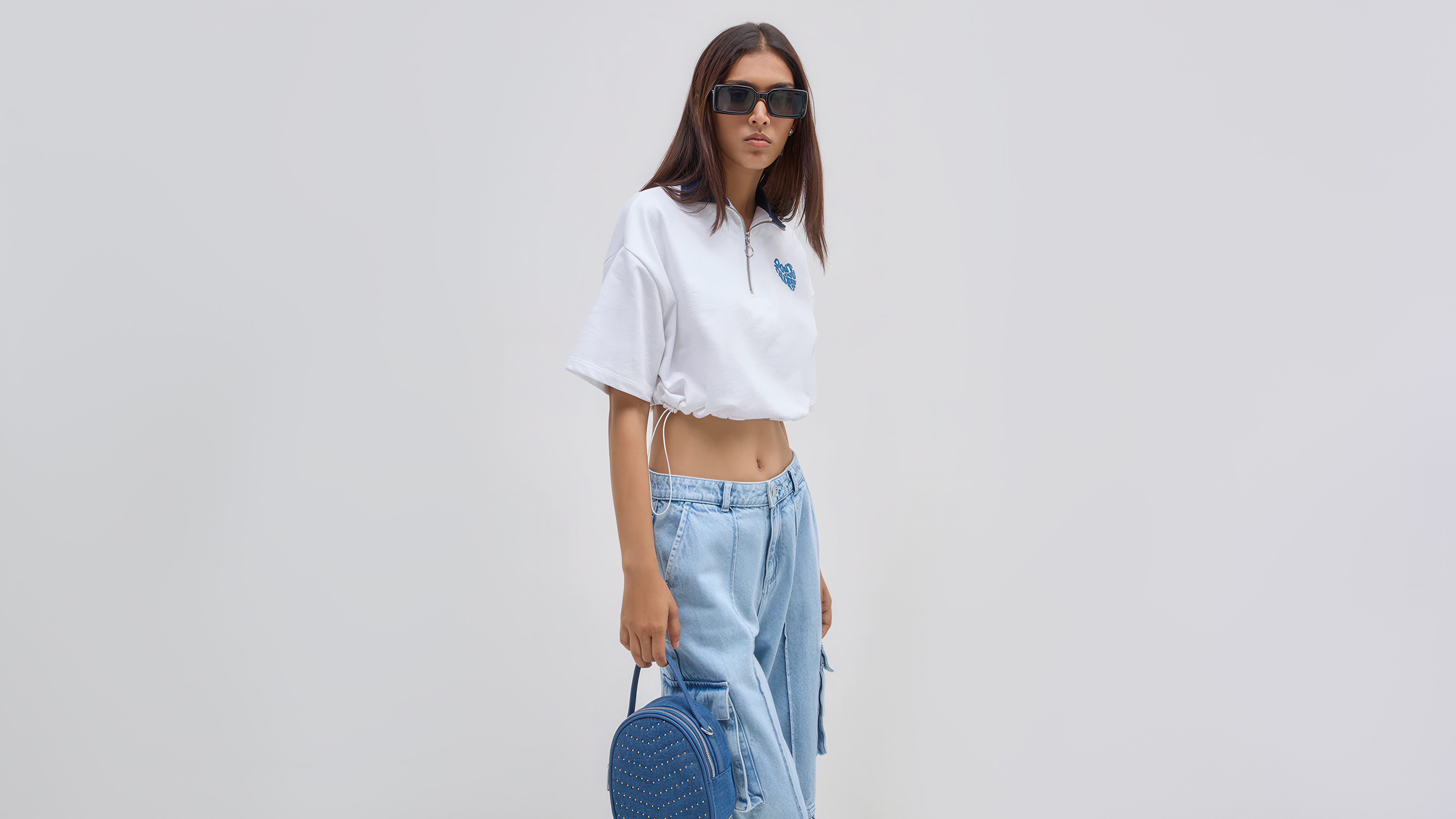 Girl in white top and blue jeans with backpack HD Wallpaper