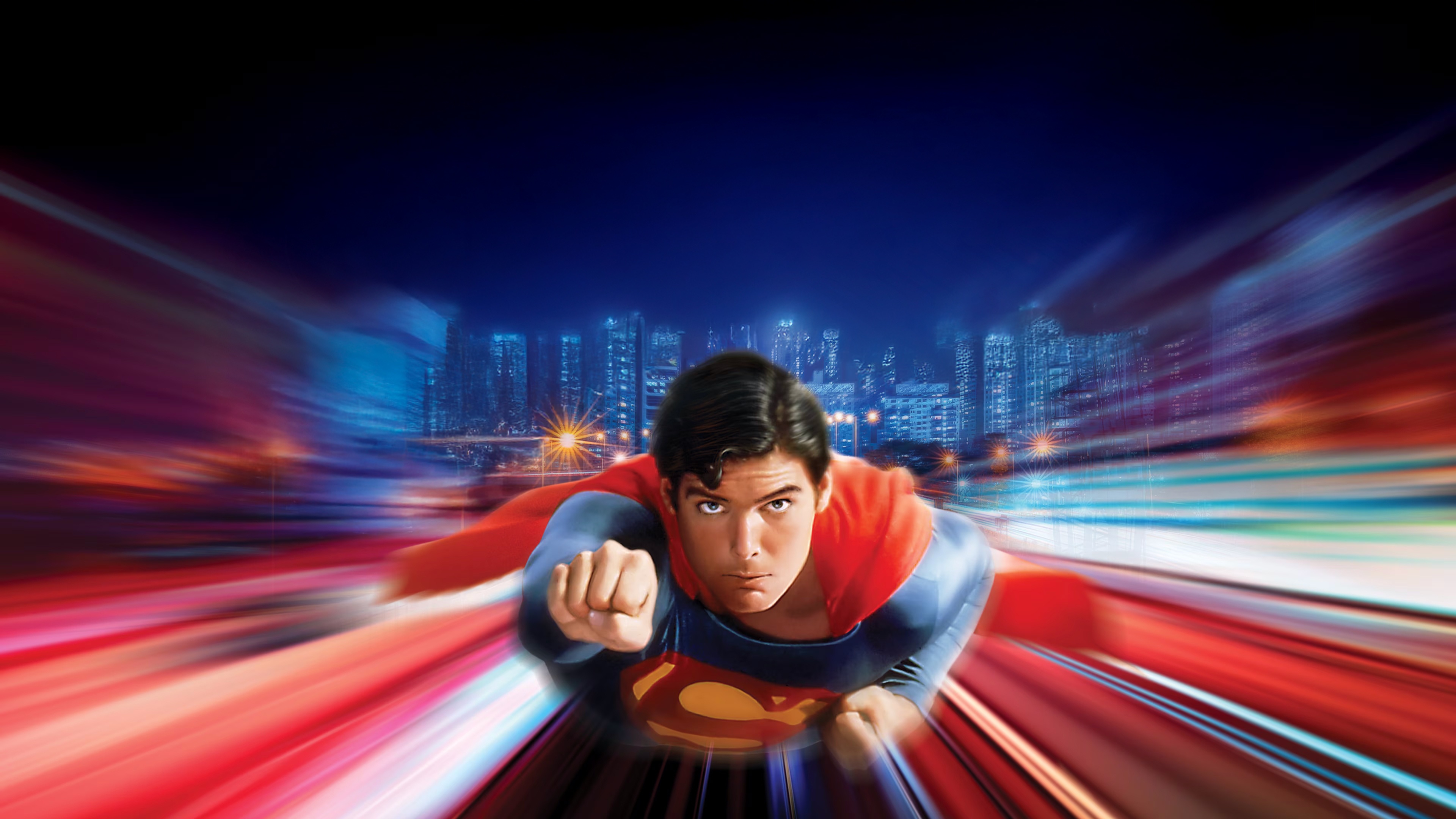 Christopher Reeve as Superman flying through a city at night HD Wallpaper