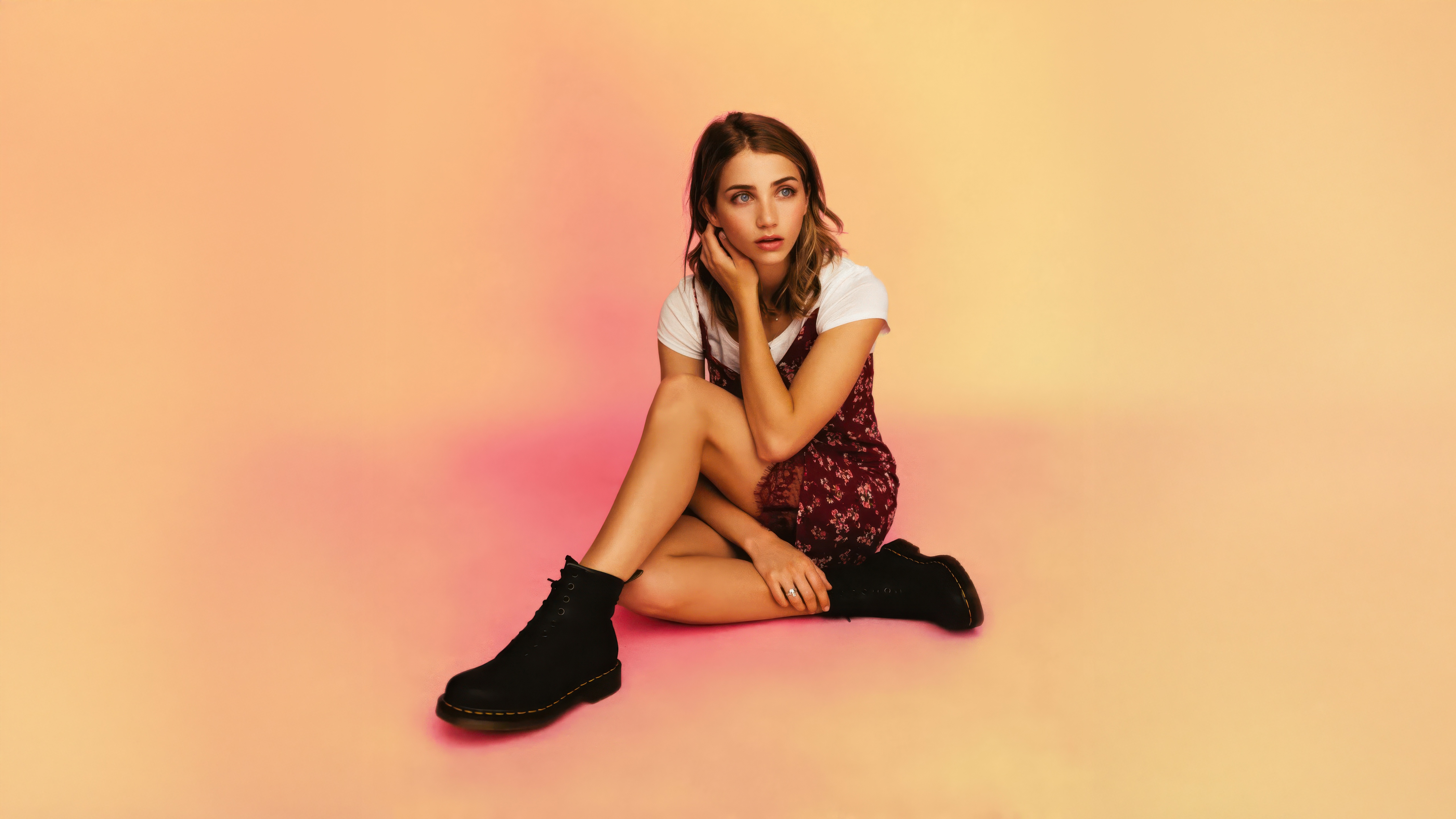 Emily Rudd sitting on a pink and orange background HD Wallpaper