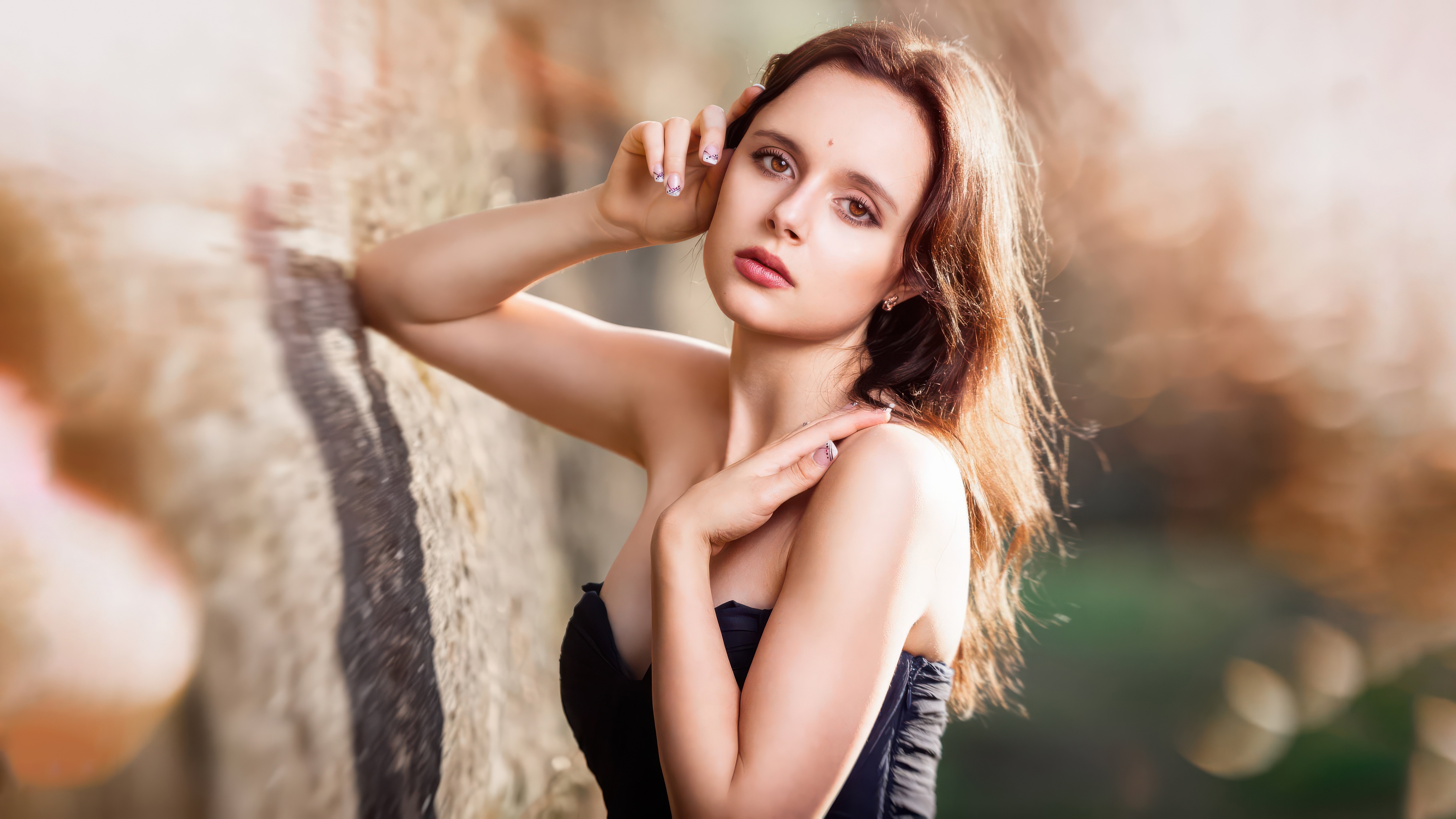 Woman posing against a rock formation HD Wallpaper
