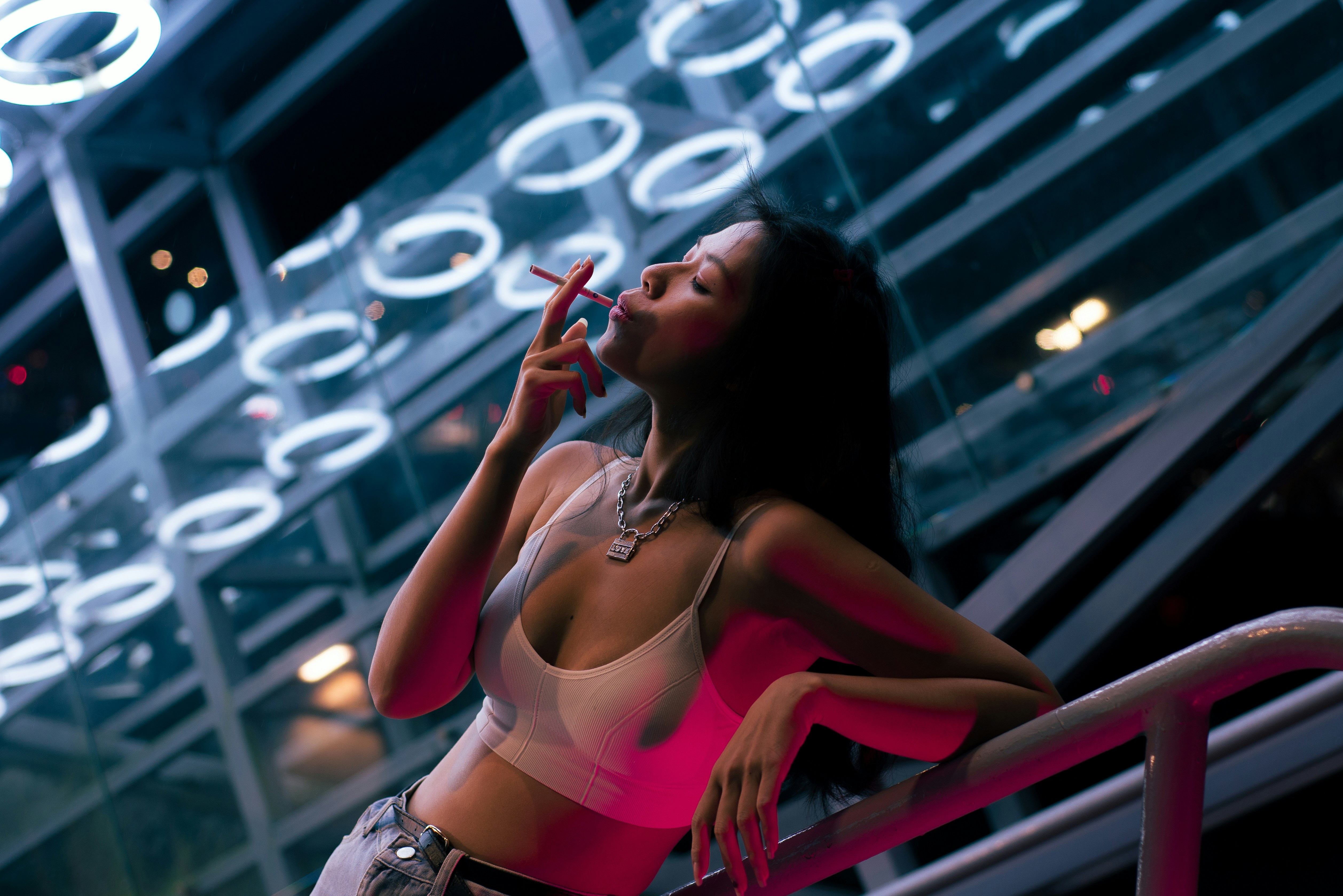 Woman smoking a cigarette with neon lights HD Wallpaper