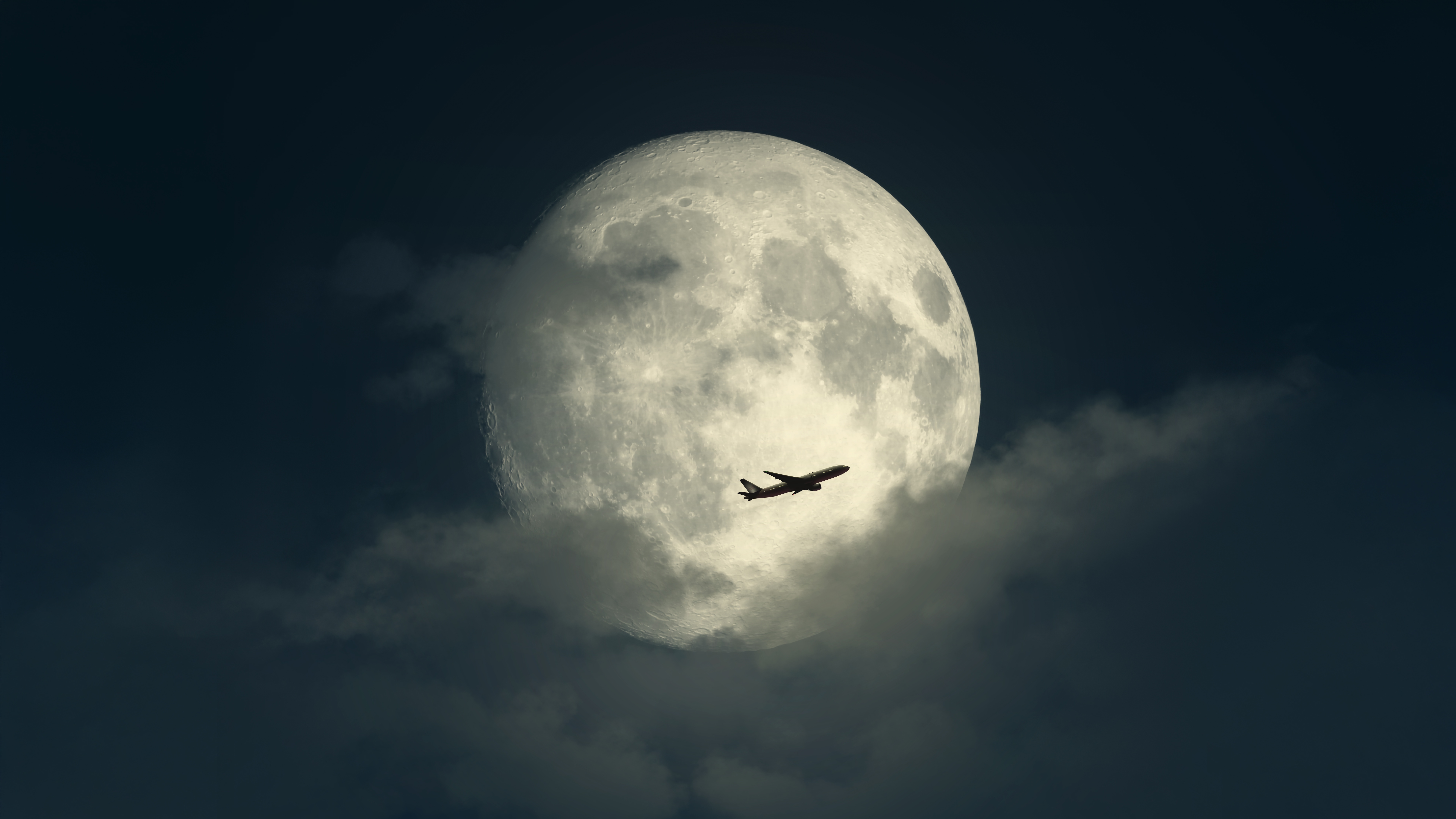 Airplane flying in front of a large full moon HD Wallpaper