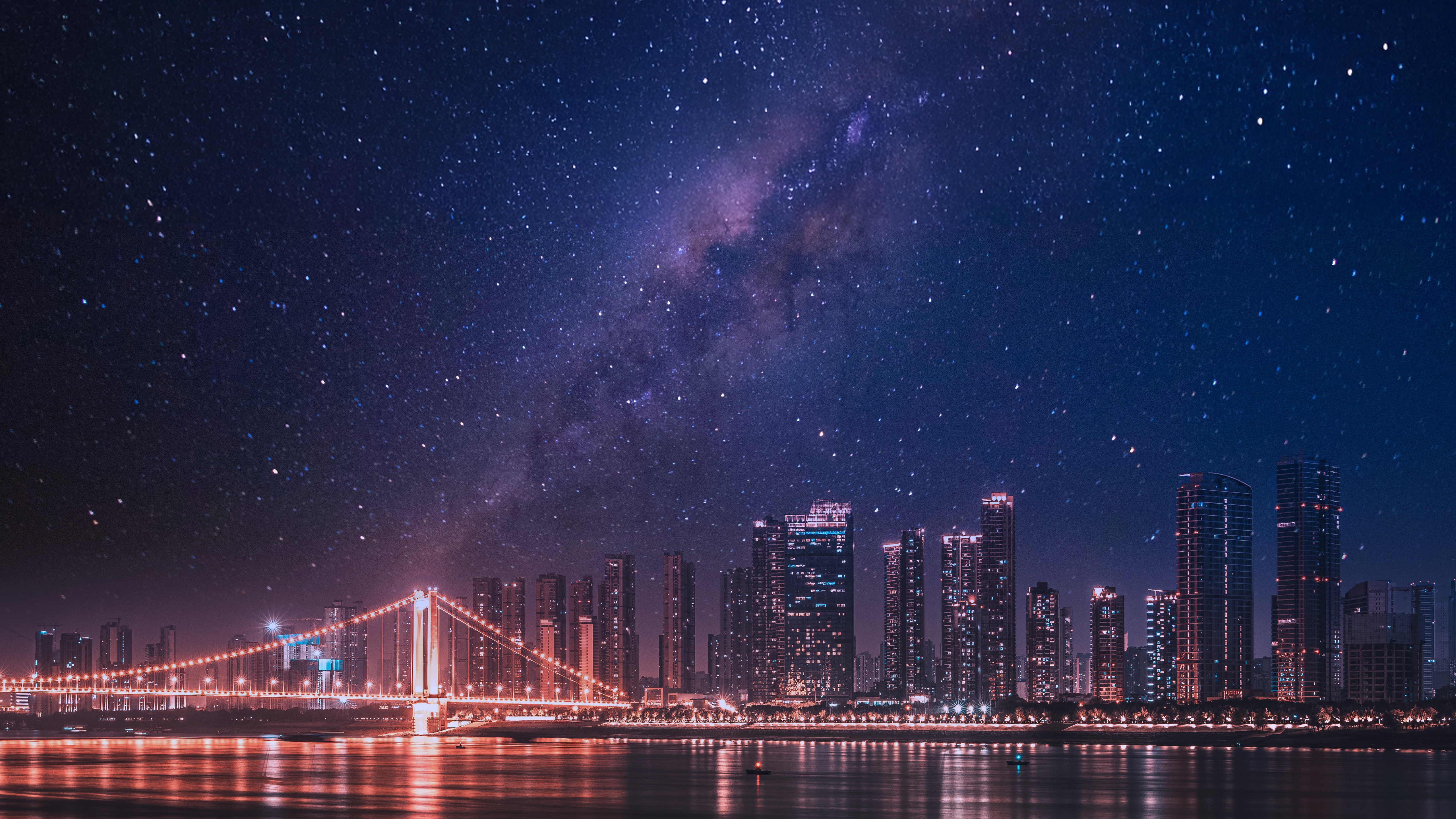 Cityscape with bridge under starry sky HD Wallpaper