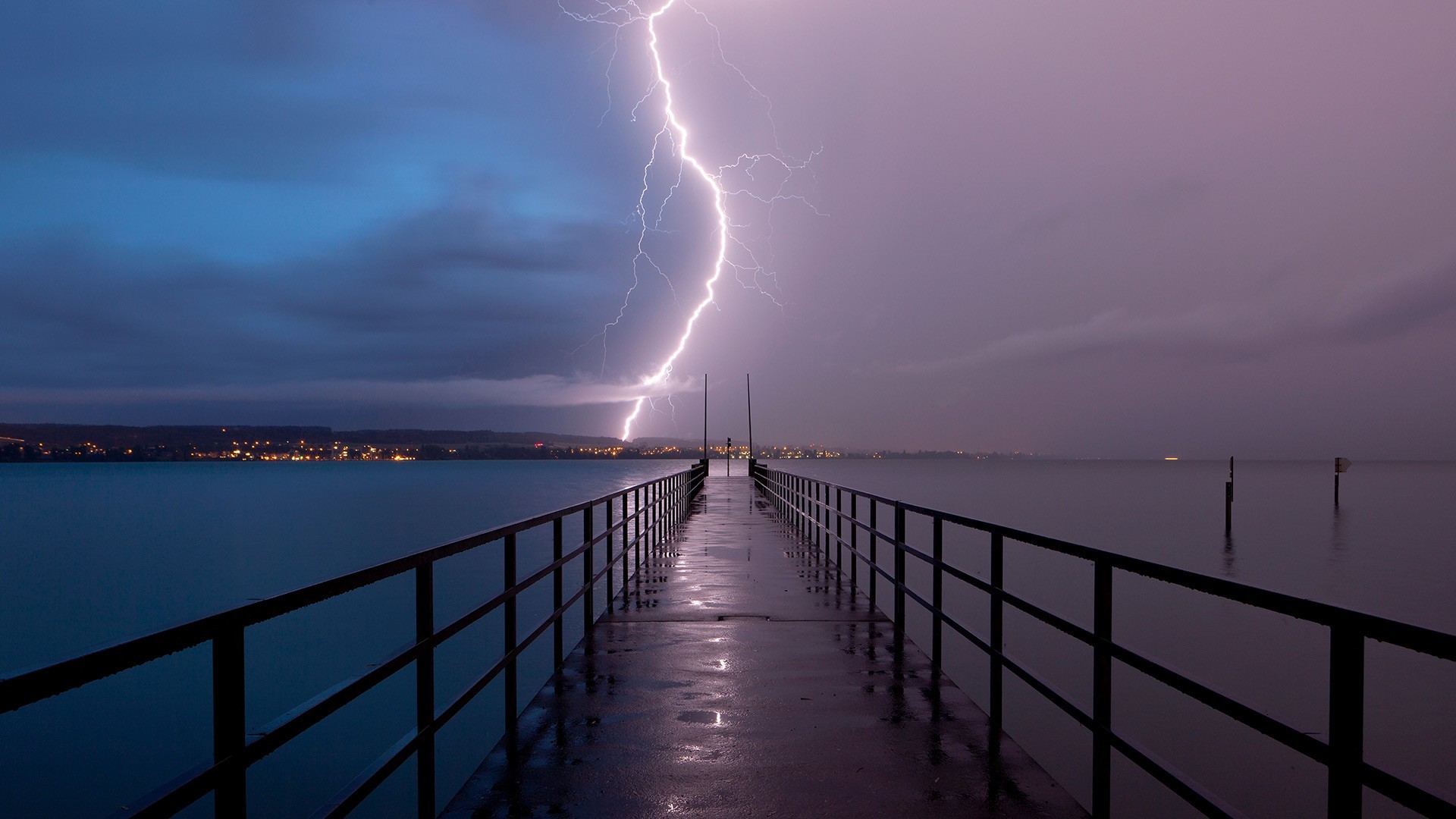Lightning strike over a pier and town at dusk HD Wallpaper