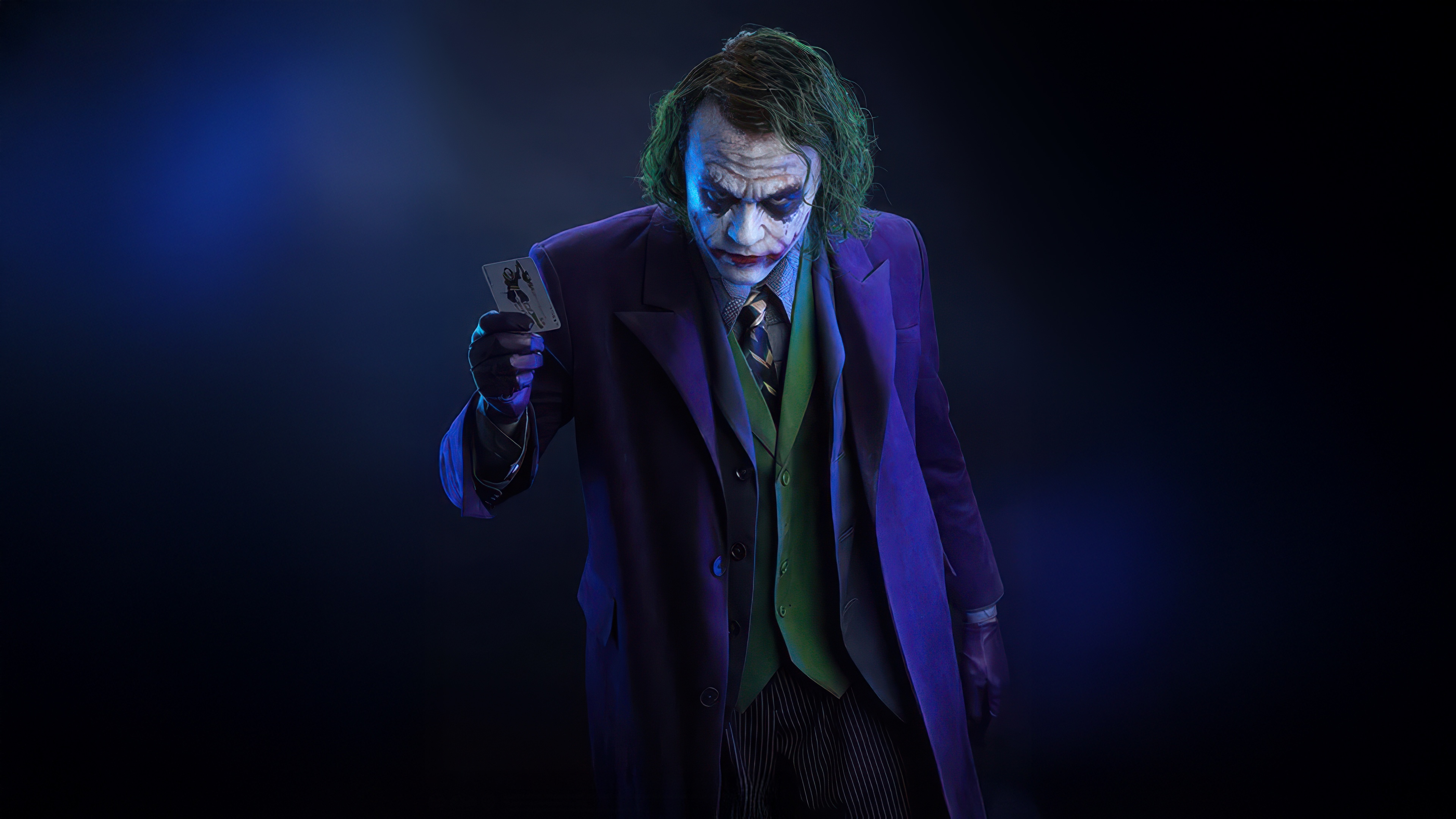 The Joker Holding a Playing Card HD Wallpaper