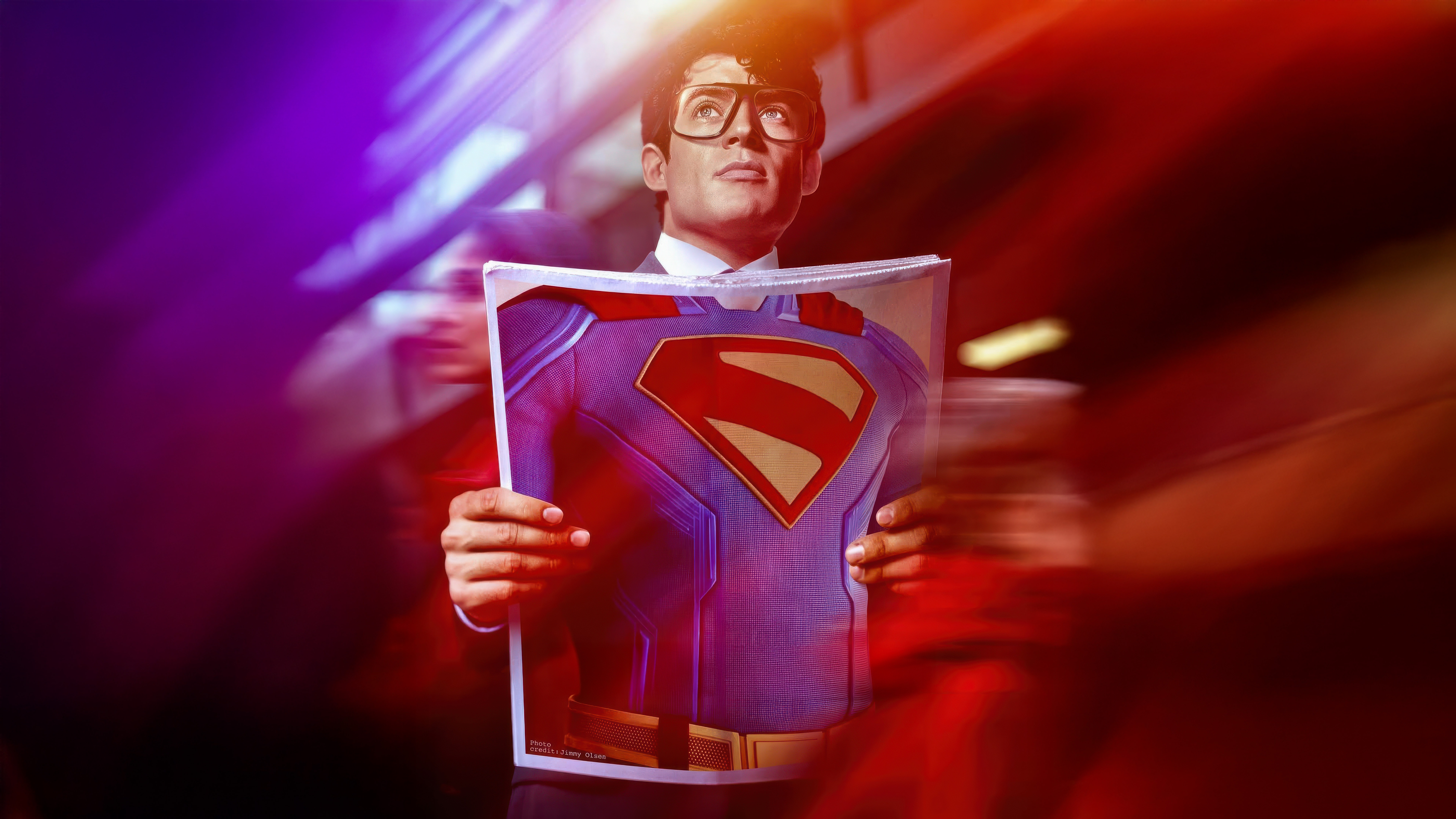 Superman holding a picture of his costume HD Wallpaper