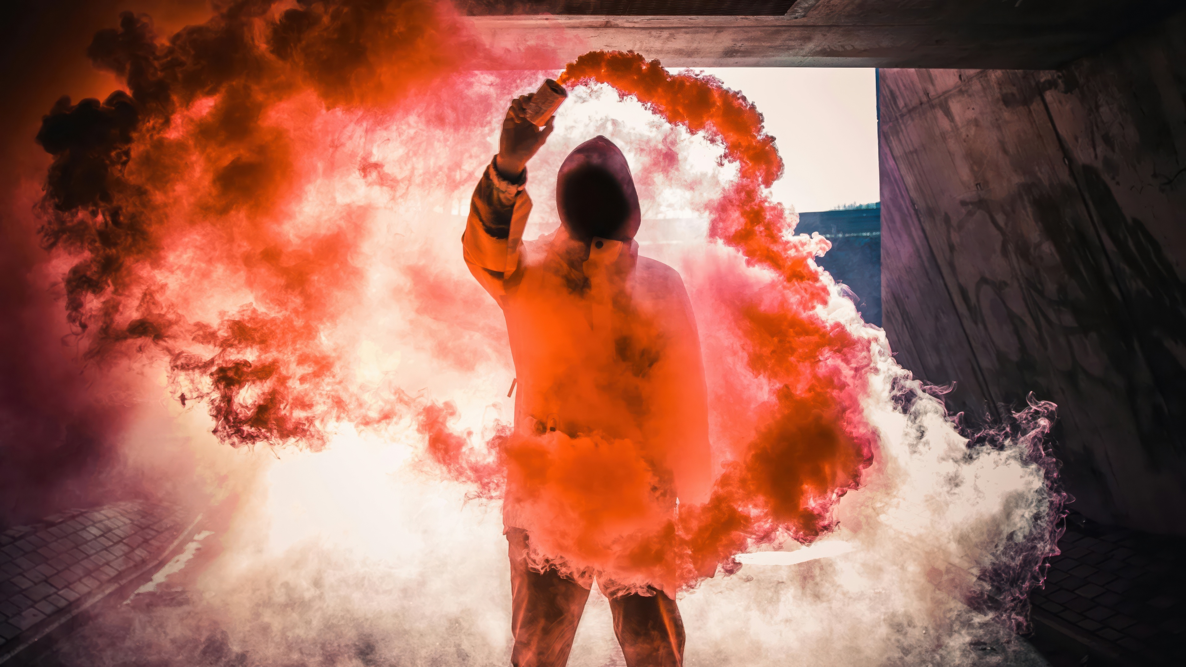 Person holding a smoke bomb in a concrete tunnel HD Wallpaper