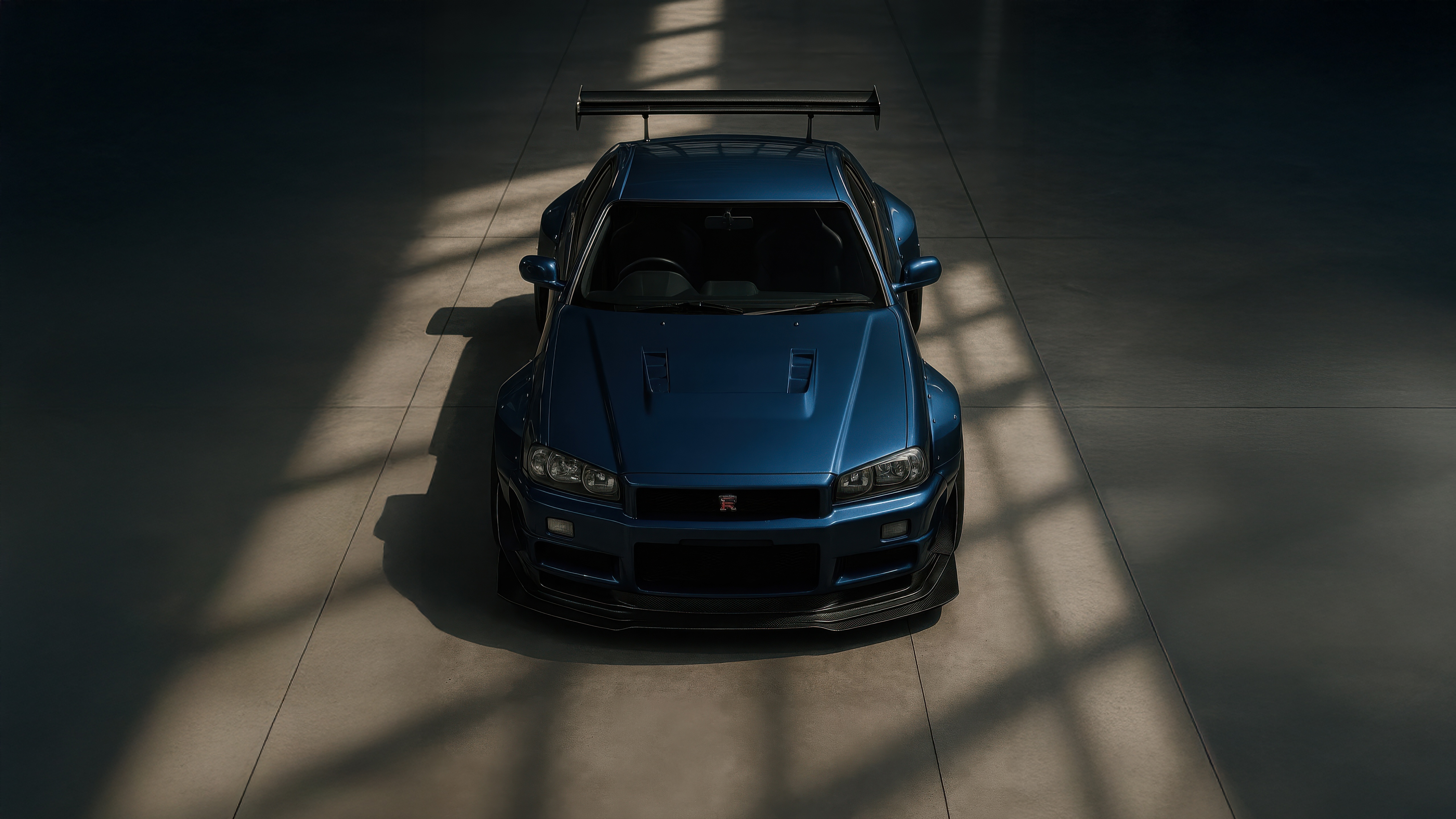Blue Nissan Skyline GT-R R34 with a large rear wing HD Wallpaper