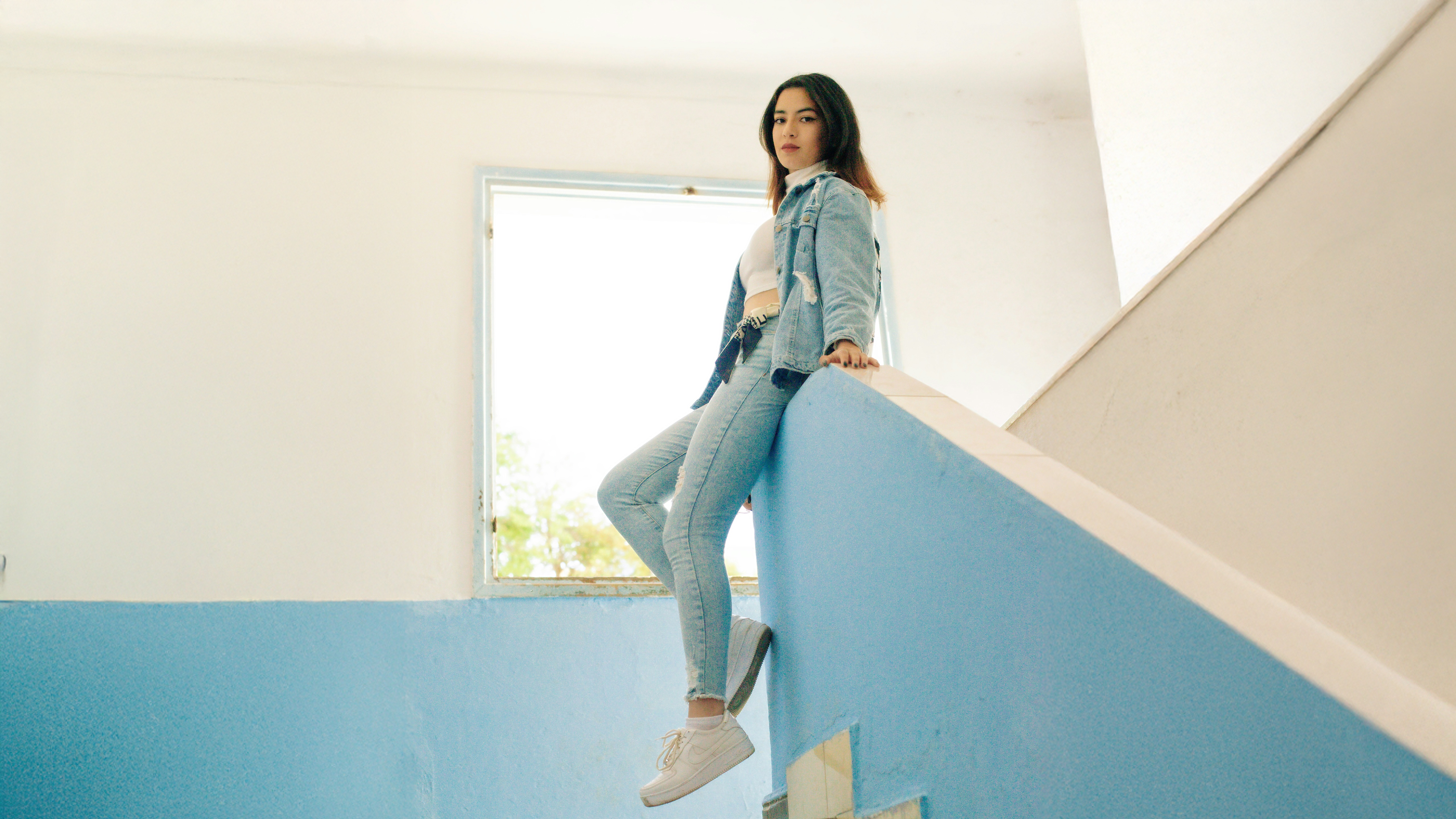Girl in Denim Posing Against Blue Wall HD Wallpaper