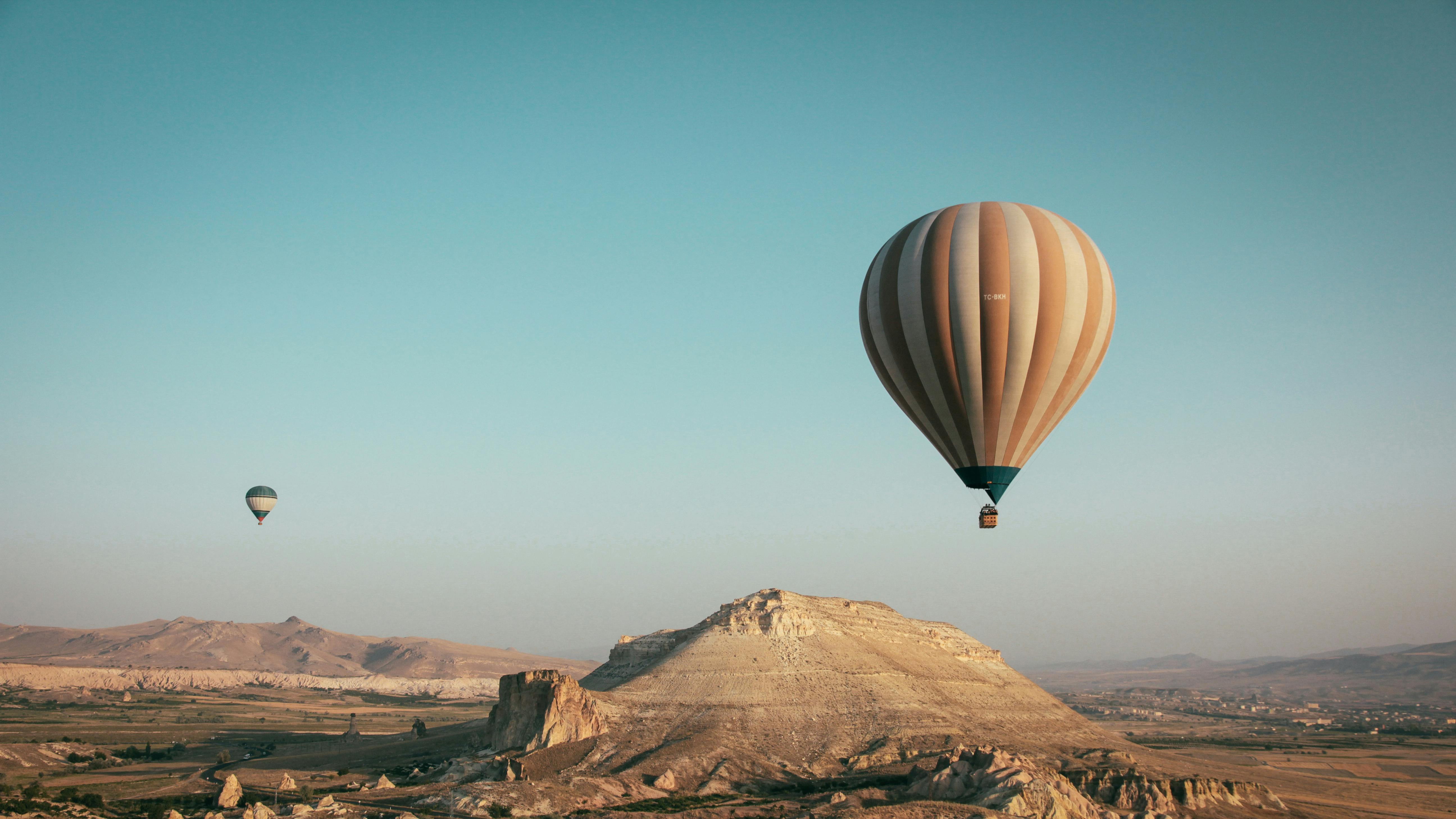 Hot Air Balloons Over Desert Landscape HD Wallpaper