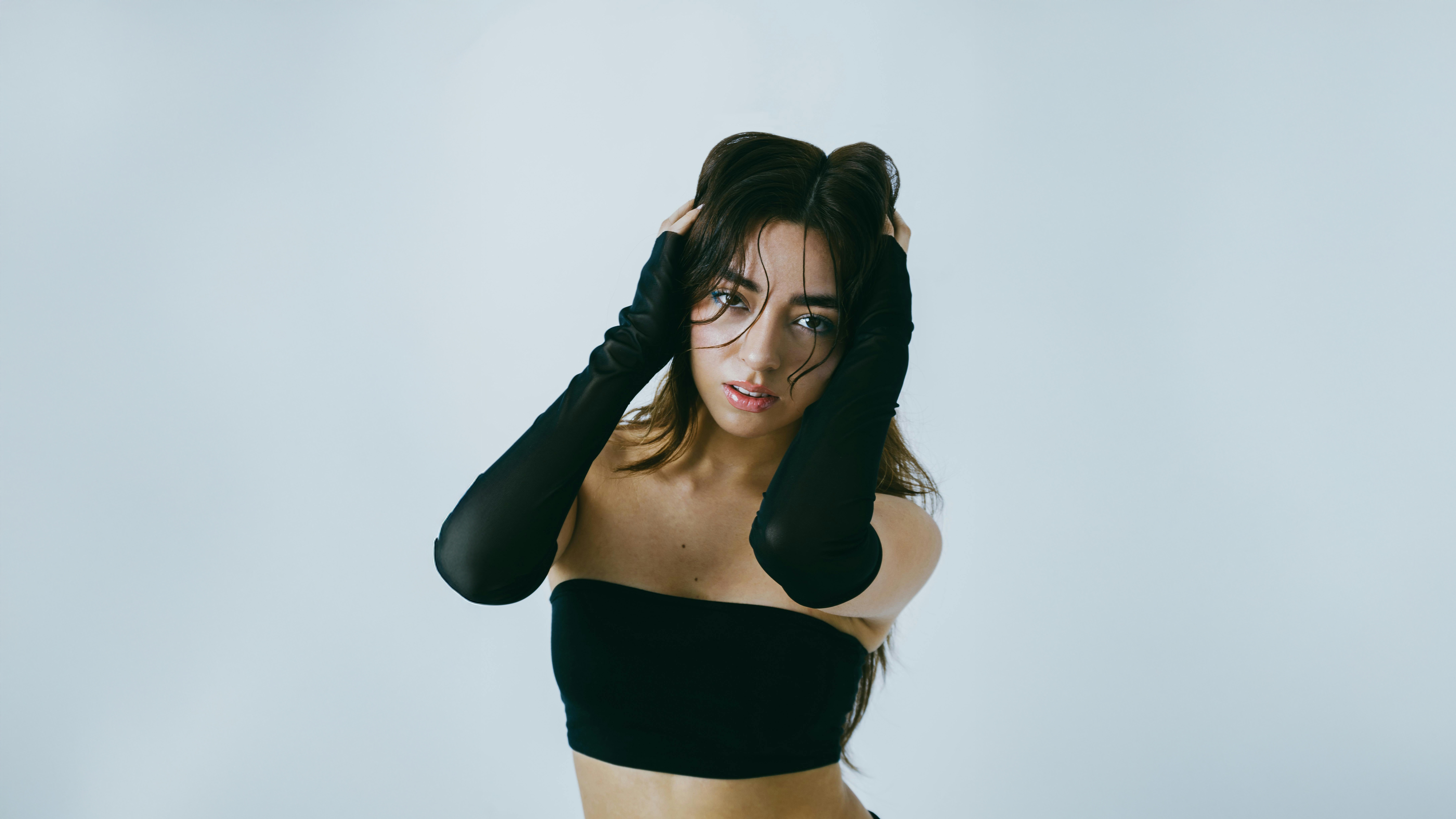 Woman in black tube top and gloves in studio HD Wallpaper