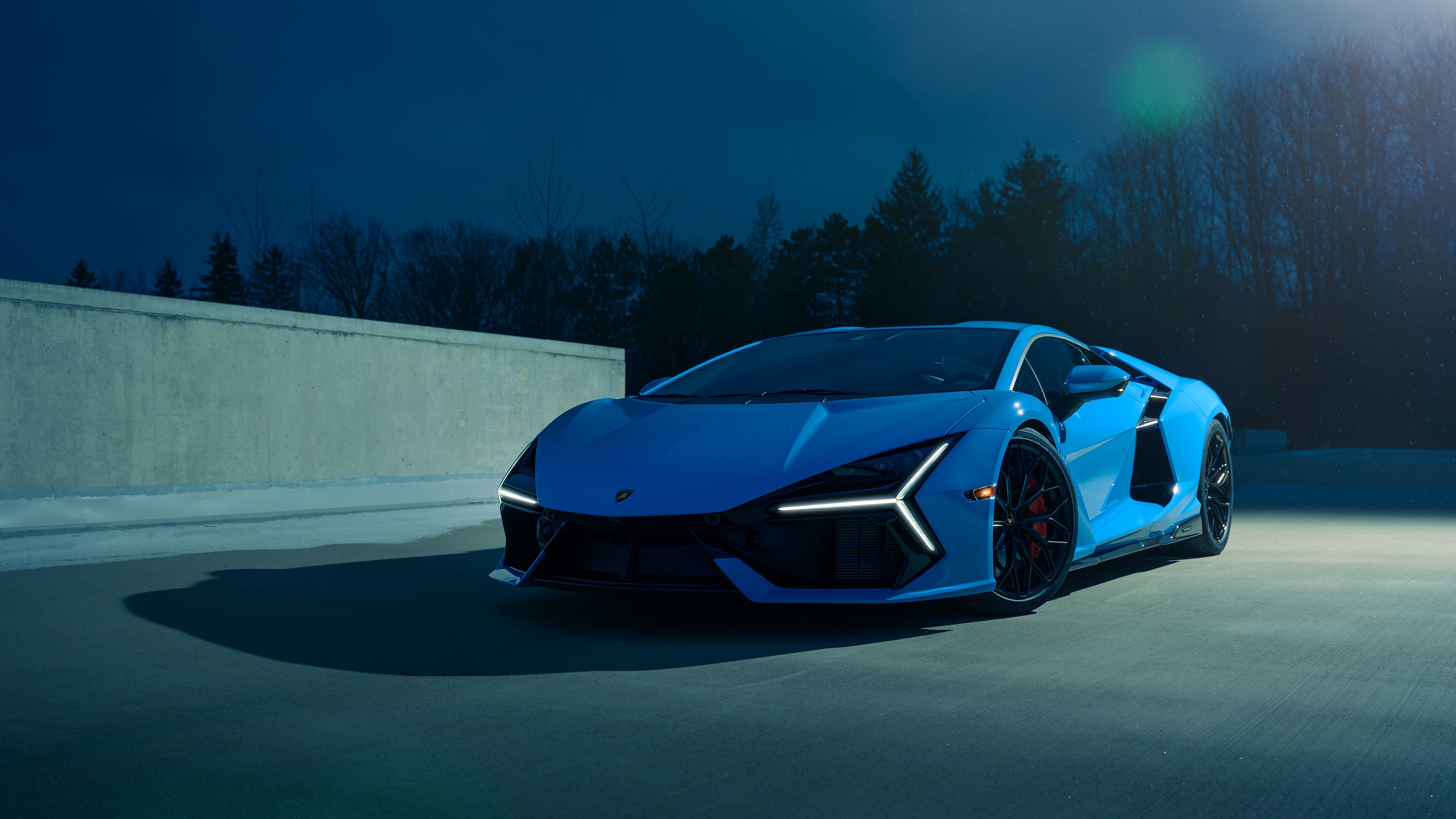 Blue Lamborghini Revuelto on a dark road HD Wallpaper