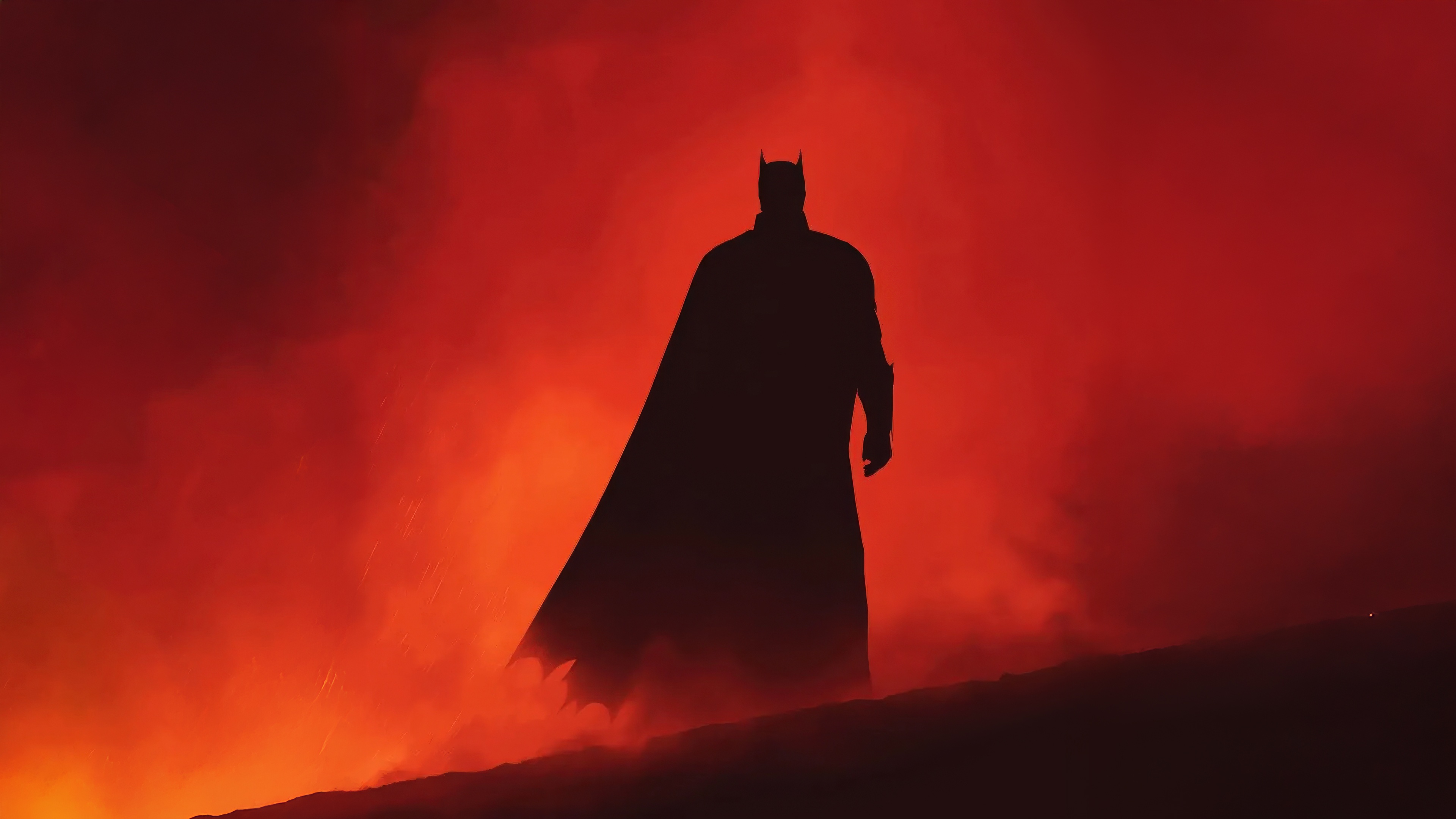 Batman in silhouette against a red, smoky background HD Wallpaper