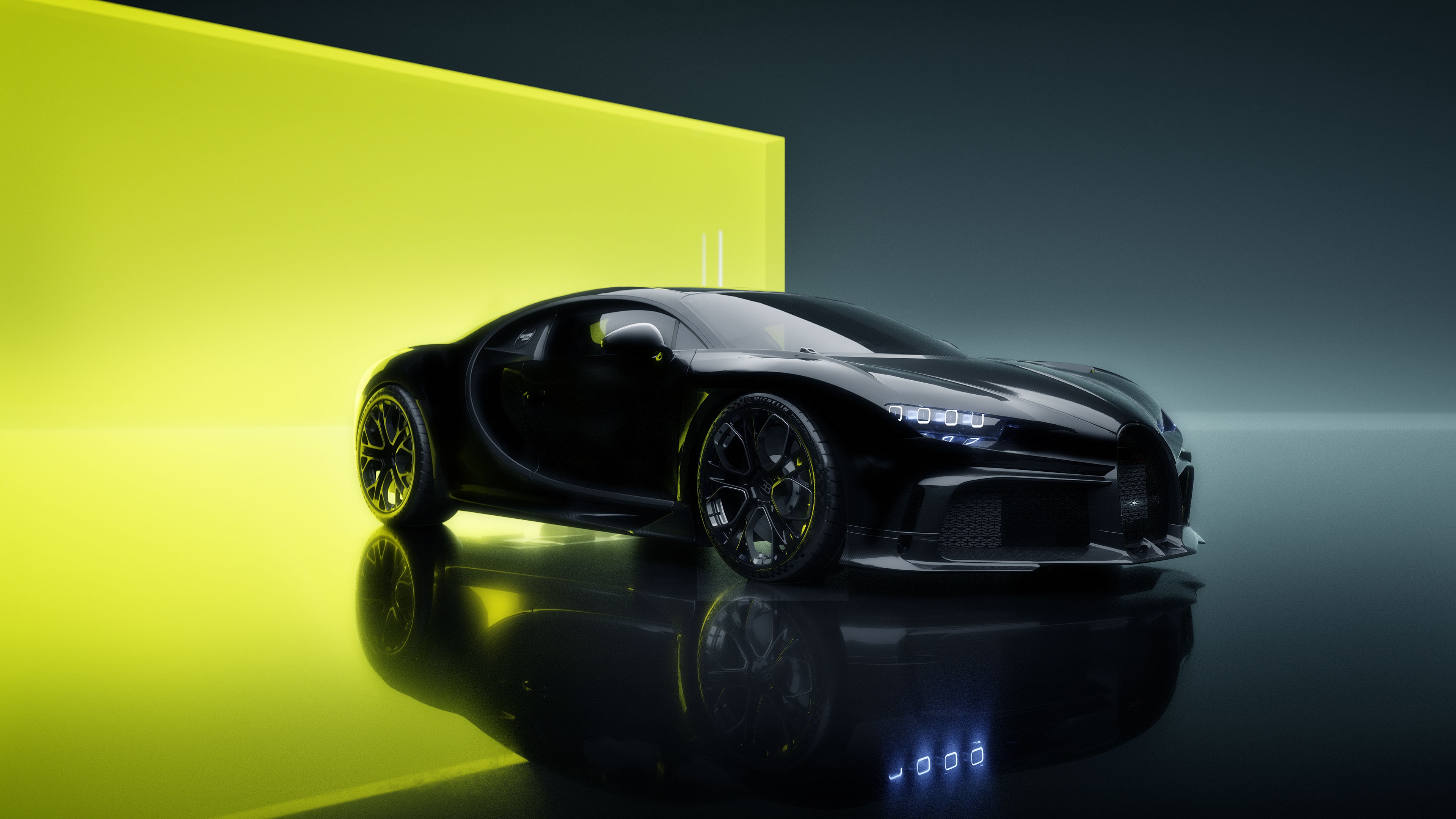 Black Bugatti Chiron on a reflective surface with yellow background HD Wallpaper