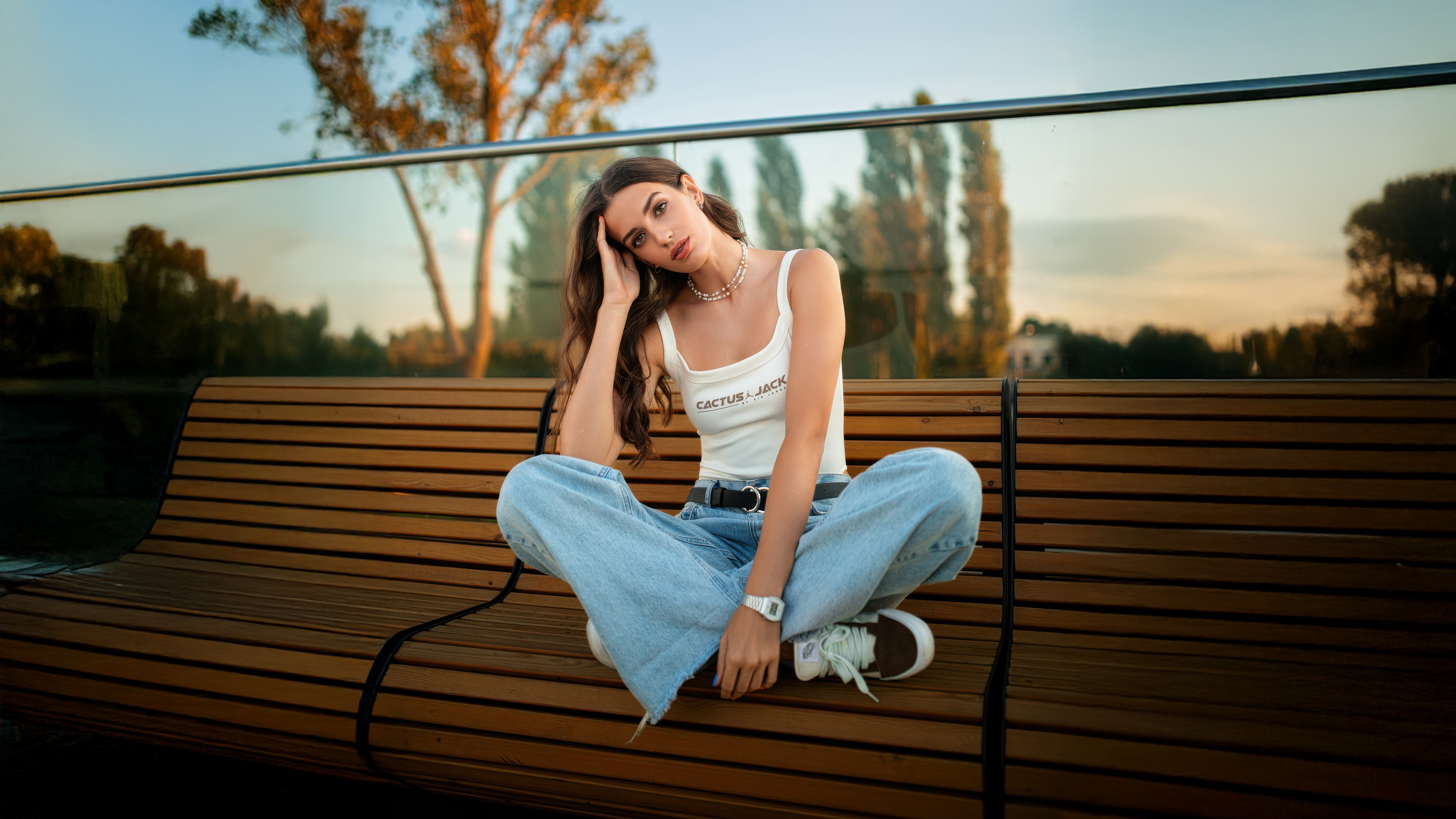 Girl in jeans sitting on a bench HD Wallpaper