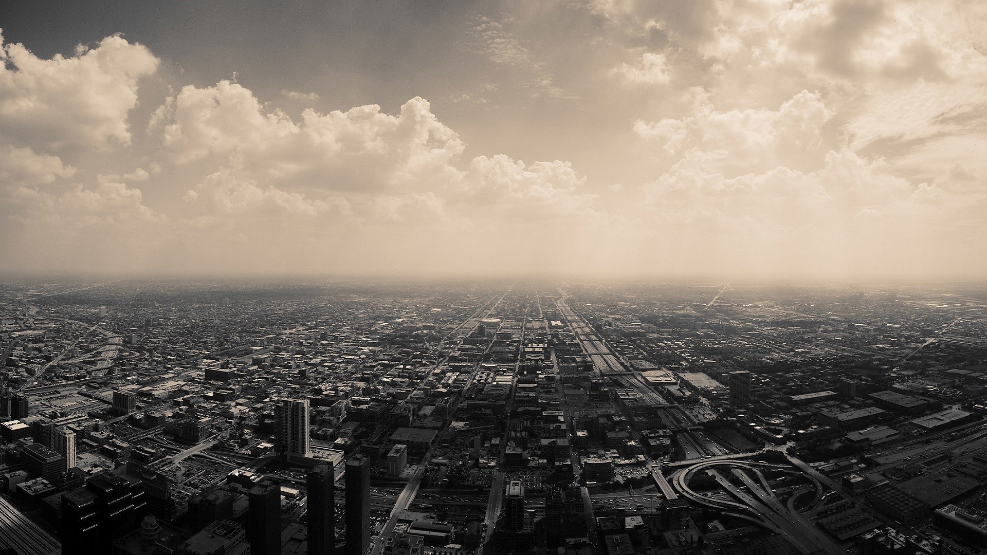 Sepia toned aerial view of Chicago cityscape with clouds HD Wallpaper