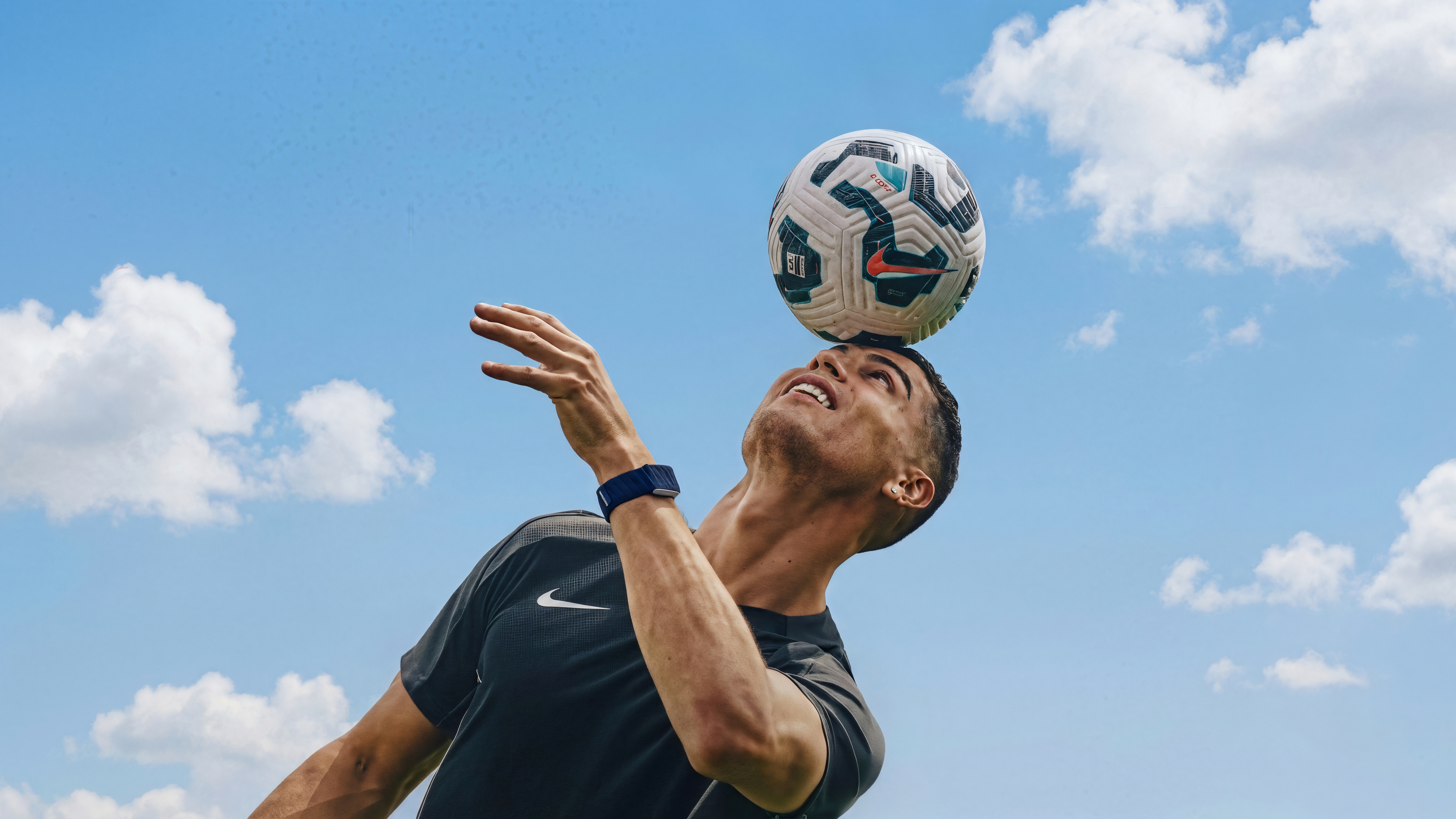 Cristiano Ronaldo balancing a soccer ball on his head HD Wallpaper