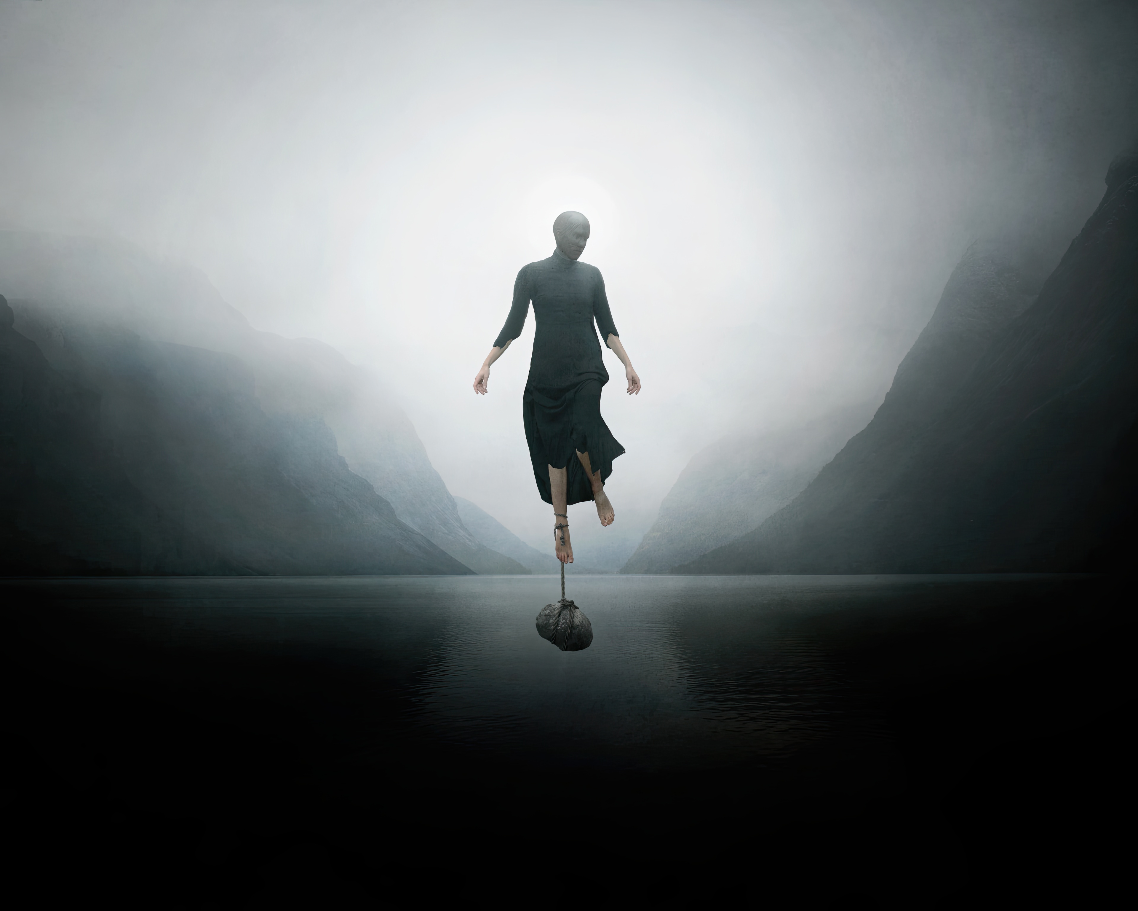 Woman balancing on a weight in a foggy landscape HD Wallpaper