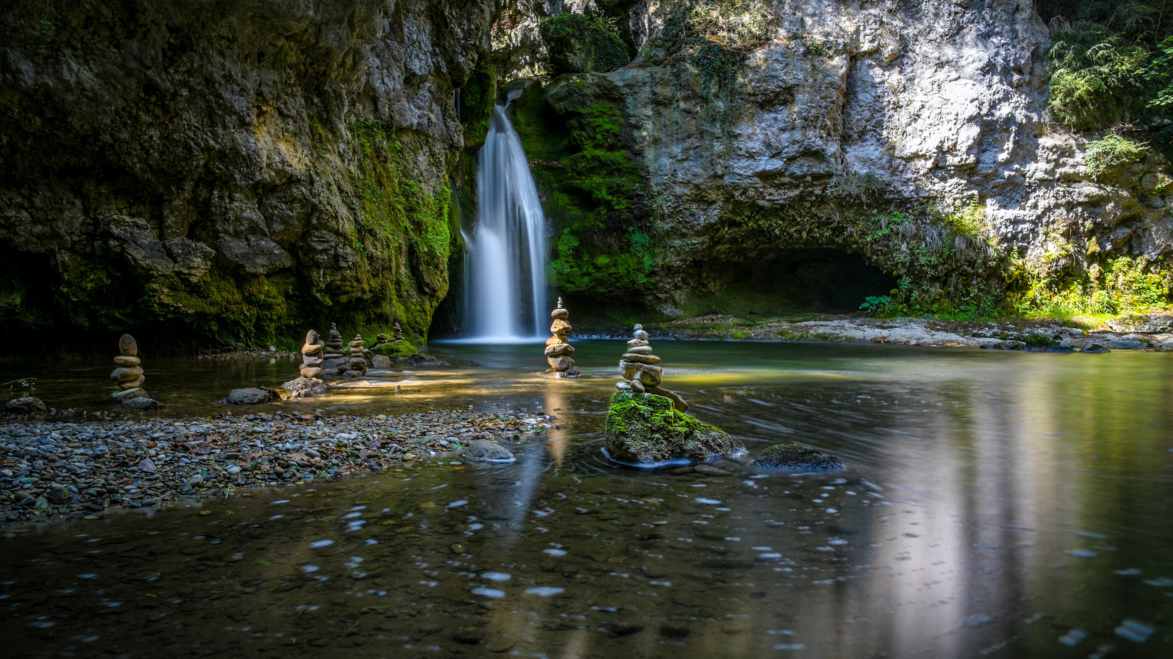 Serene Waterfall and Stone Cairns in Nature HD Wallpaper