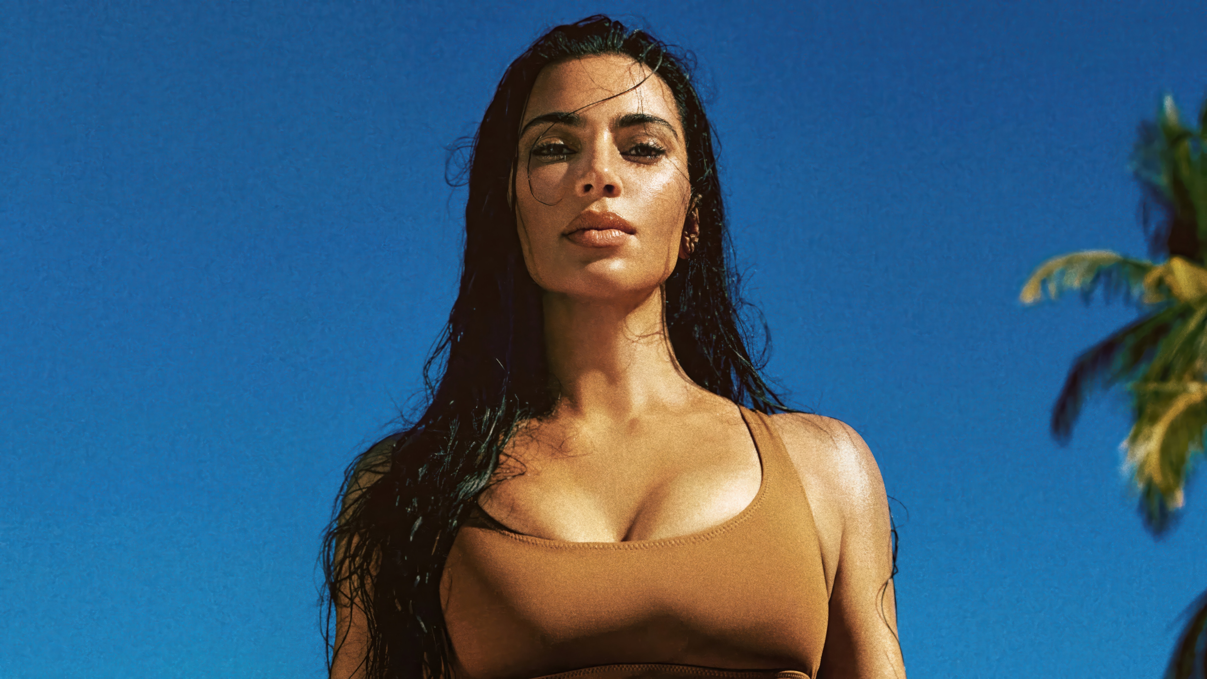 Kim Kardashian in a brown bikini against a blue sky HD Wallpaper