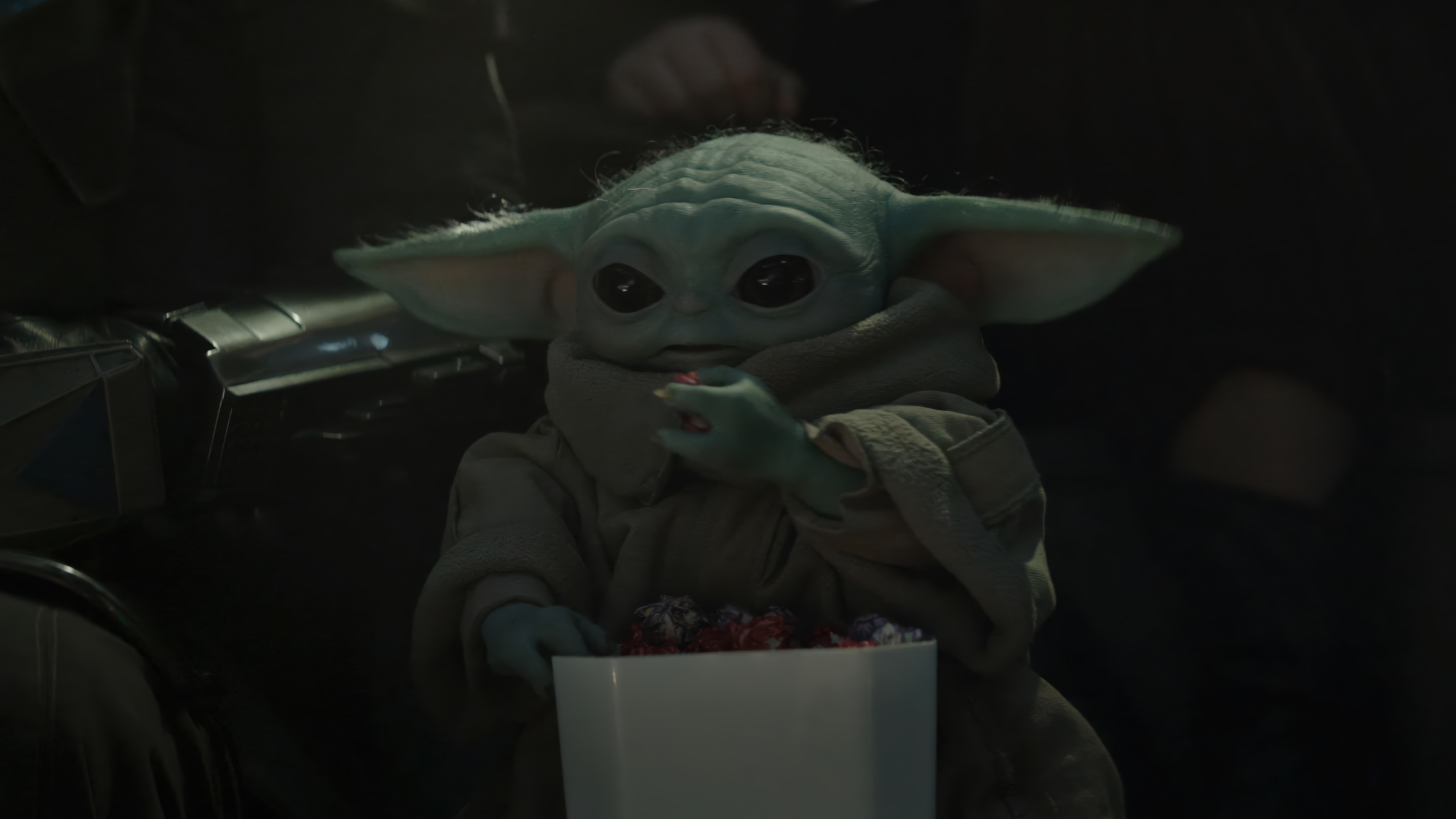 Grogu eating snacks from a bucket HD Wallpaper