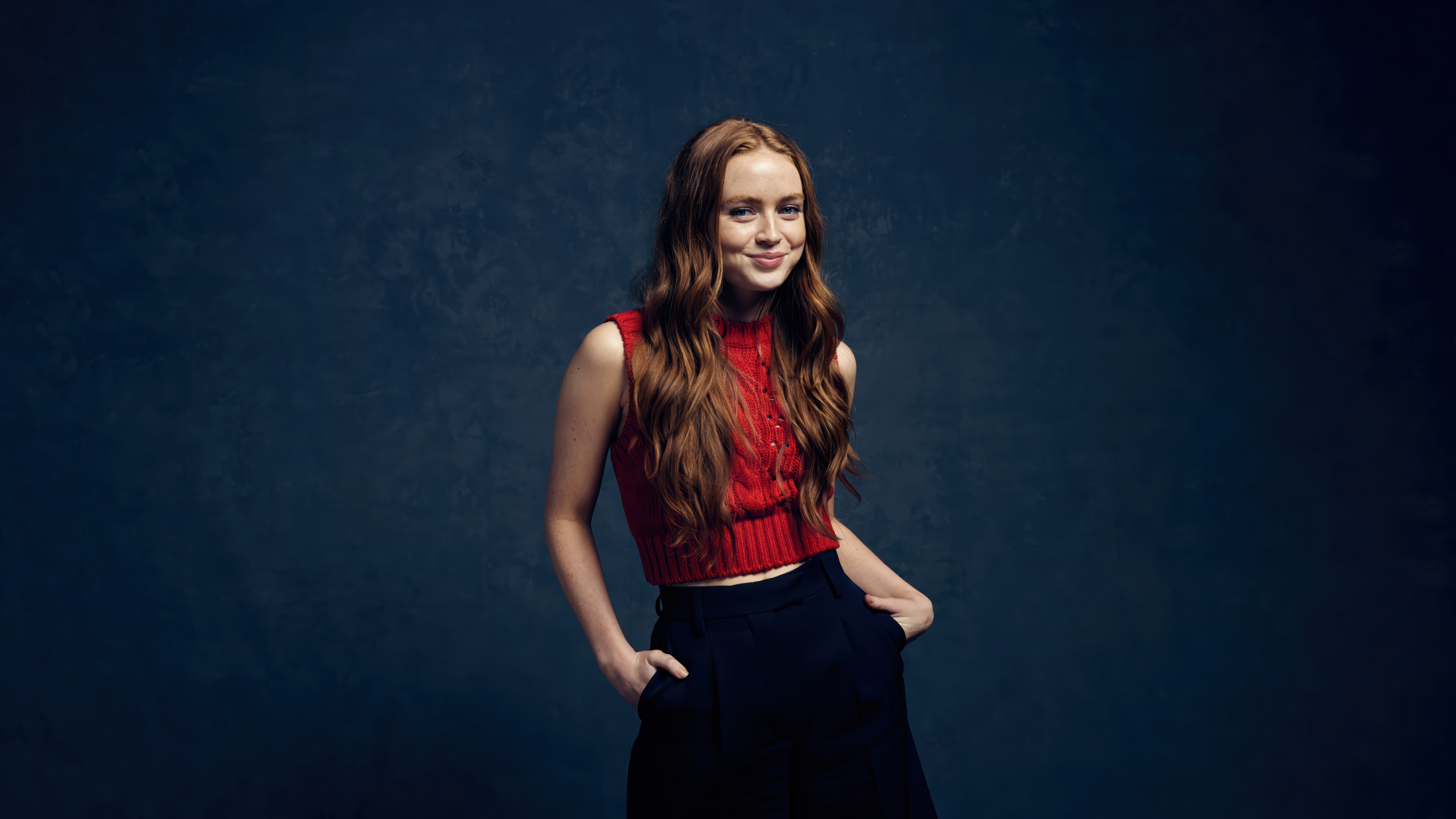 Sadie Sink in Red Top and Black Pants 4K HD Wallpaper