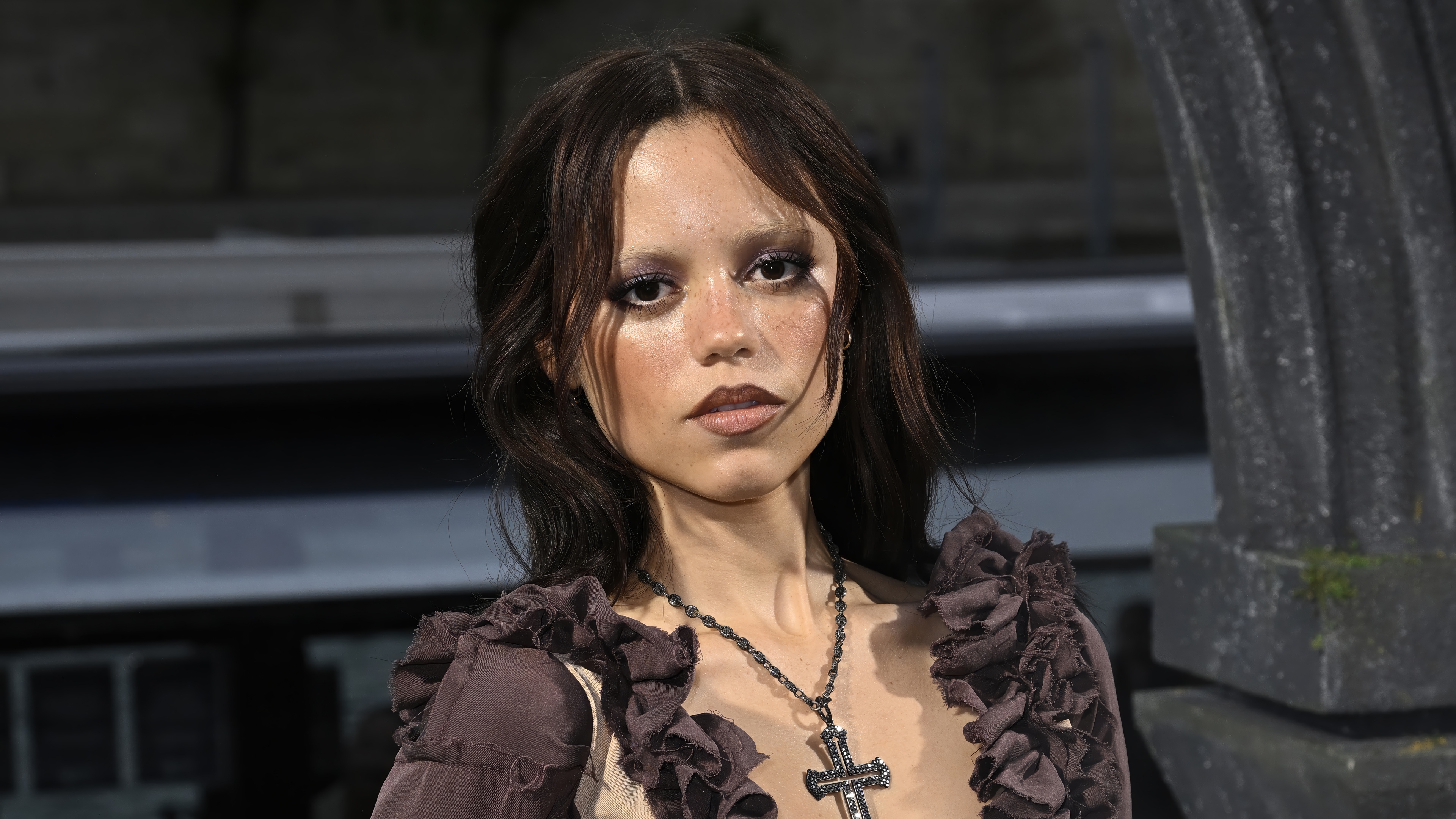 Jenna Ortega in gothic attire with cross necklace HD Wallpaper