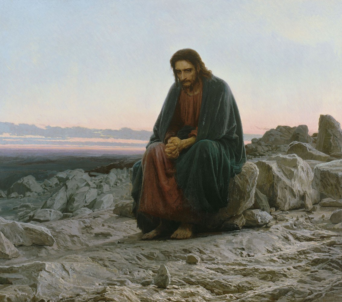 Jesus Christ sitting on rocks in a desert landscape HD Wallpaper