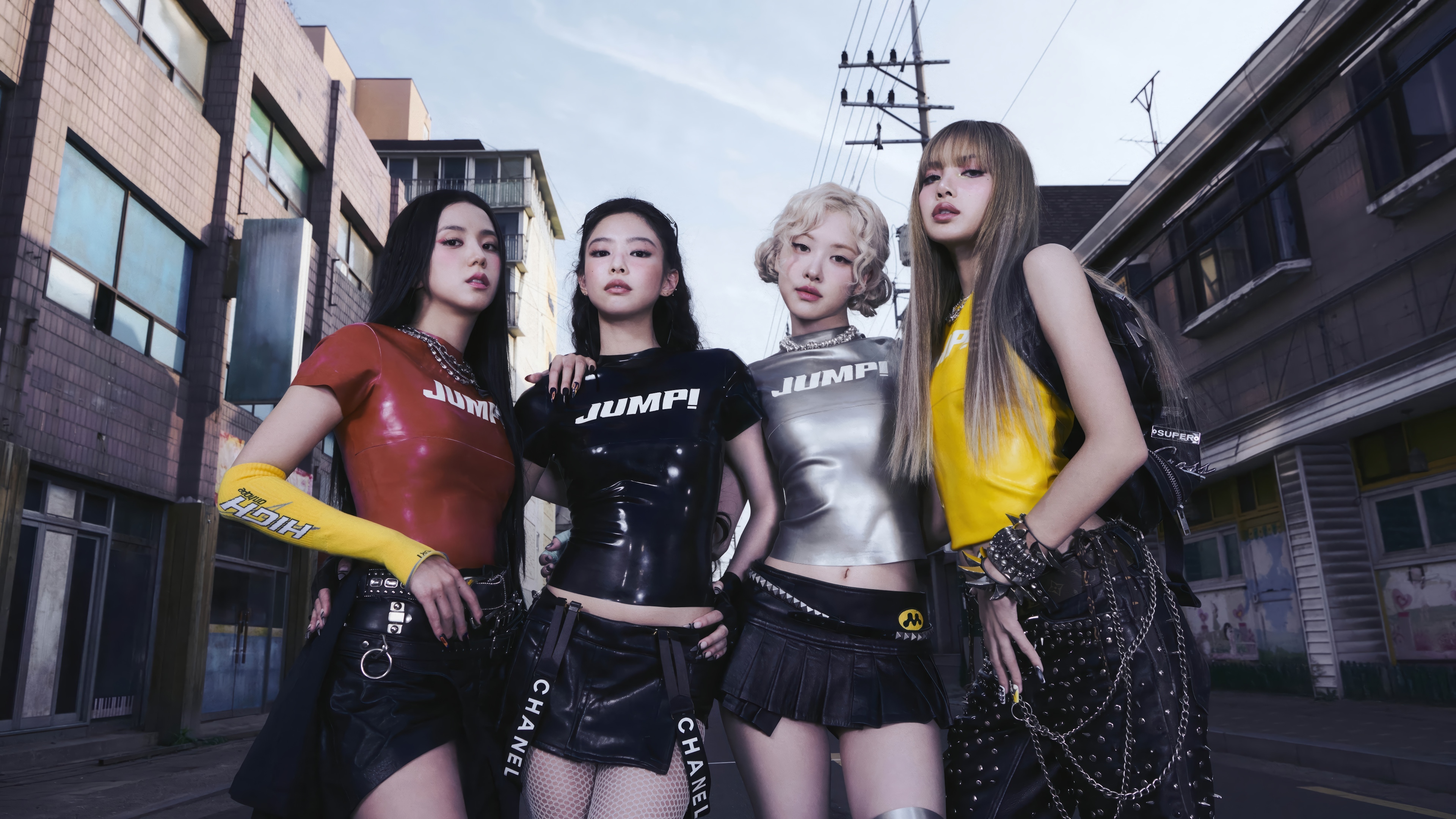 BLACKPINK members Jisoo, Jennie, Rosé, and Lisa in urban setting HD Wallpaper
