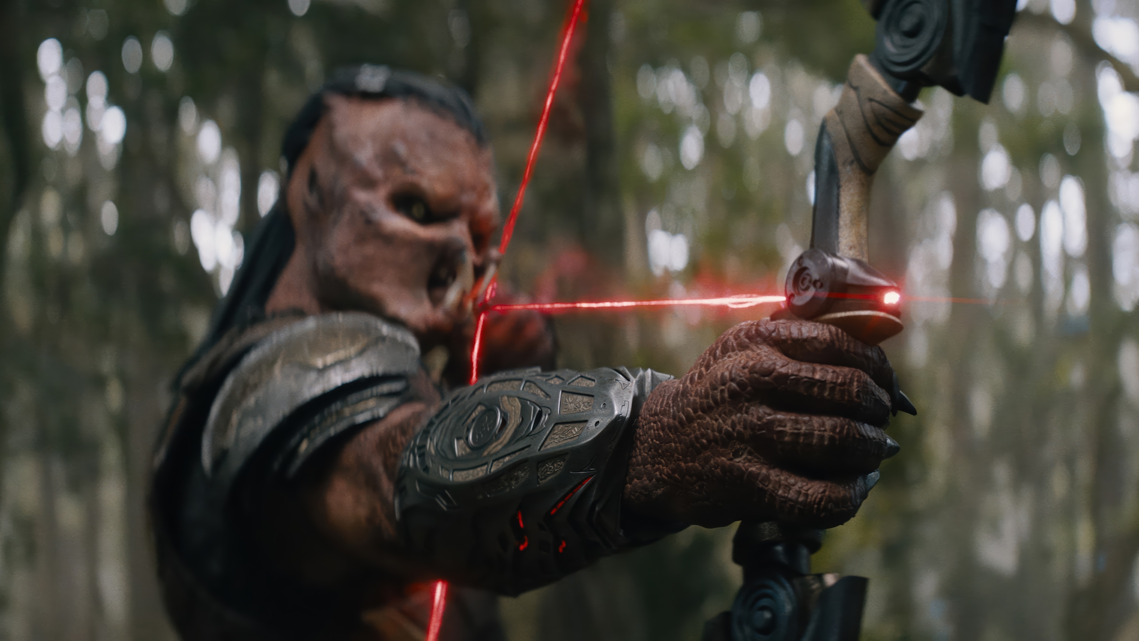 Predator aiming a bow with red laser sight HD Wallpaper
