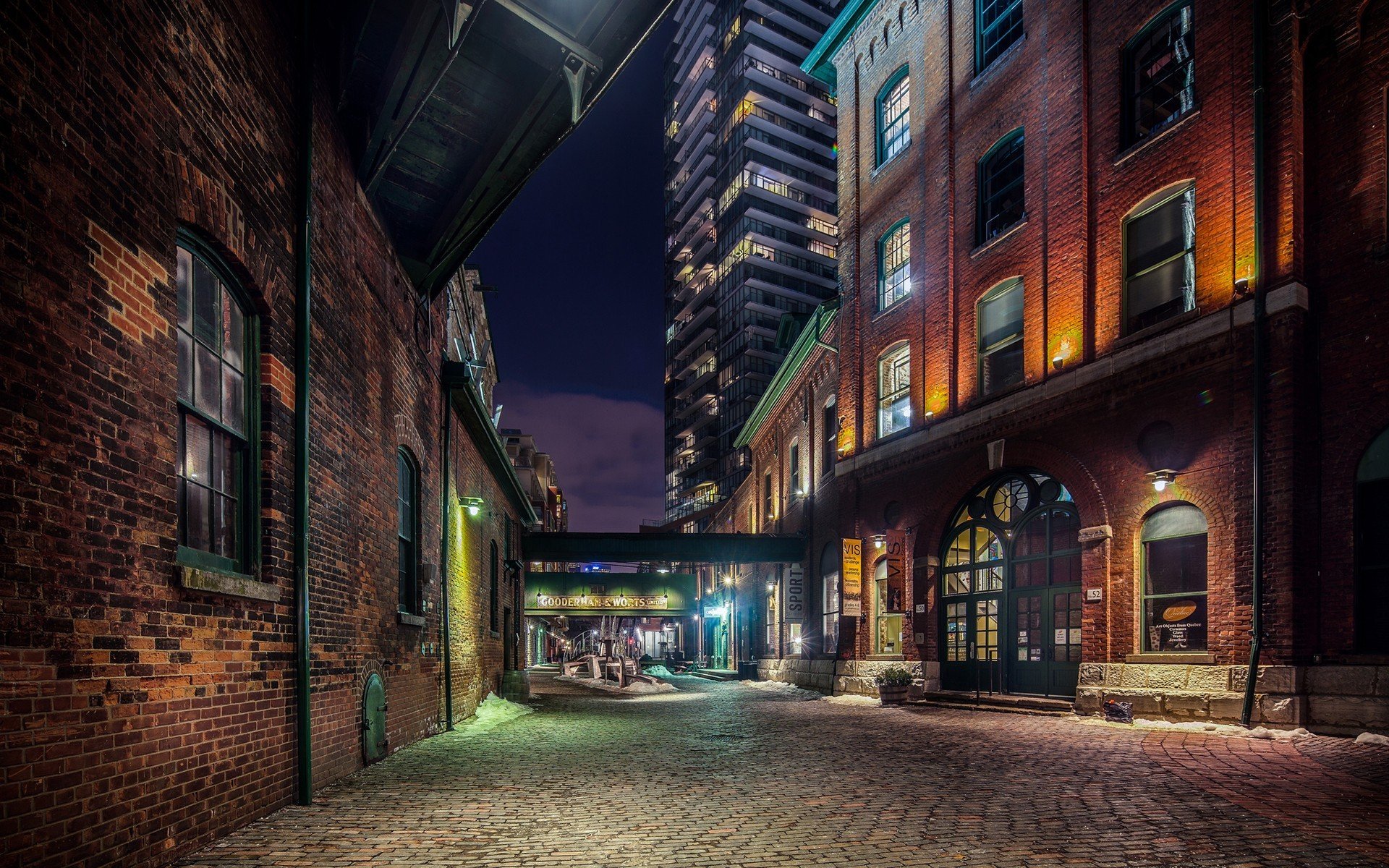 Brick buildings and modern skyscraper at night HD Wallpaper