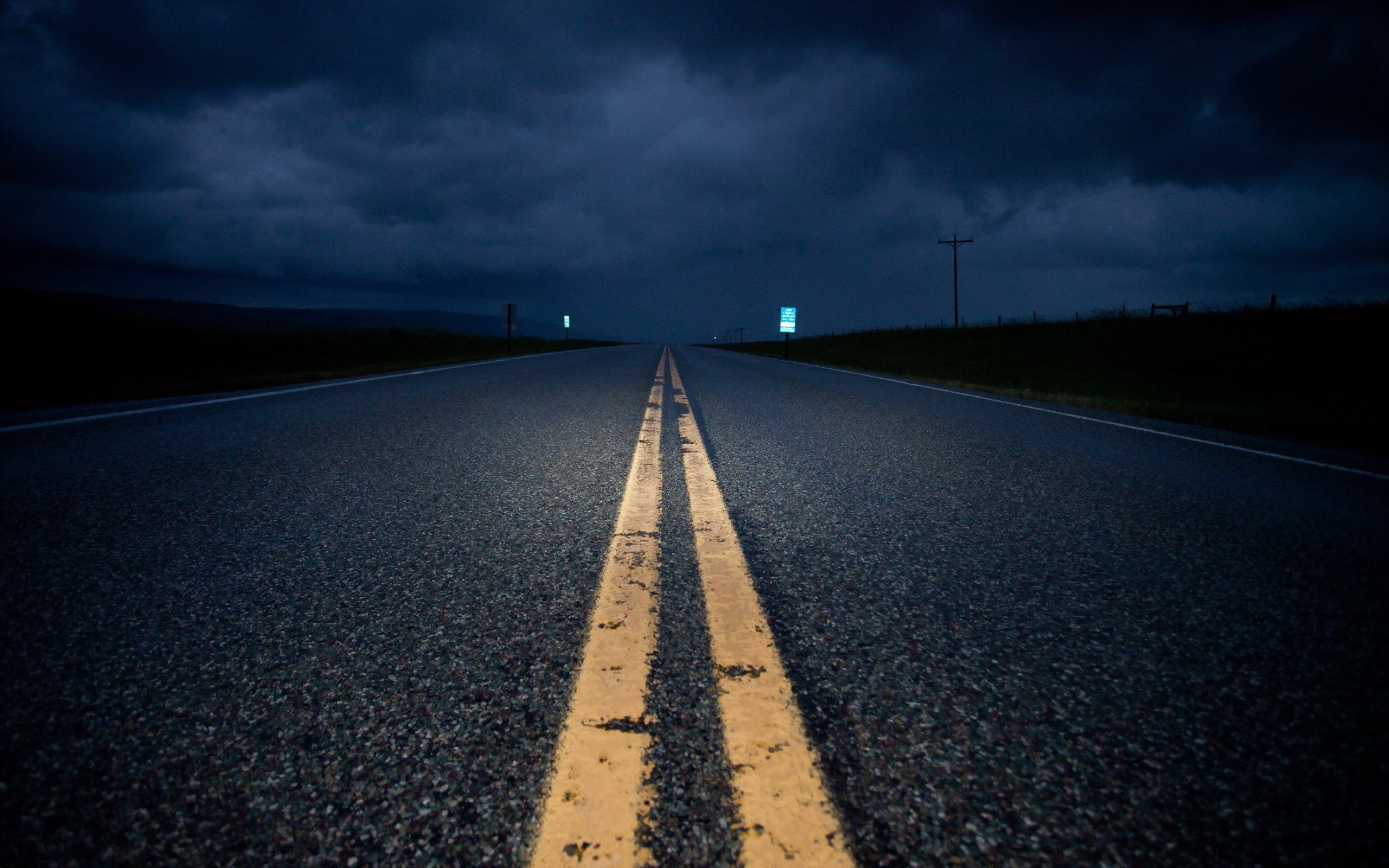 Empty road at night under dark clouds HD Wallpaper