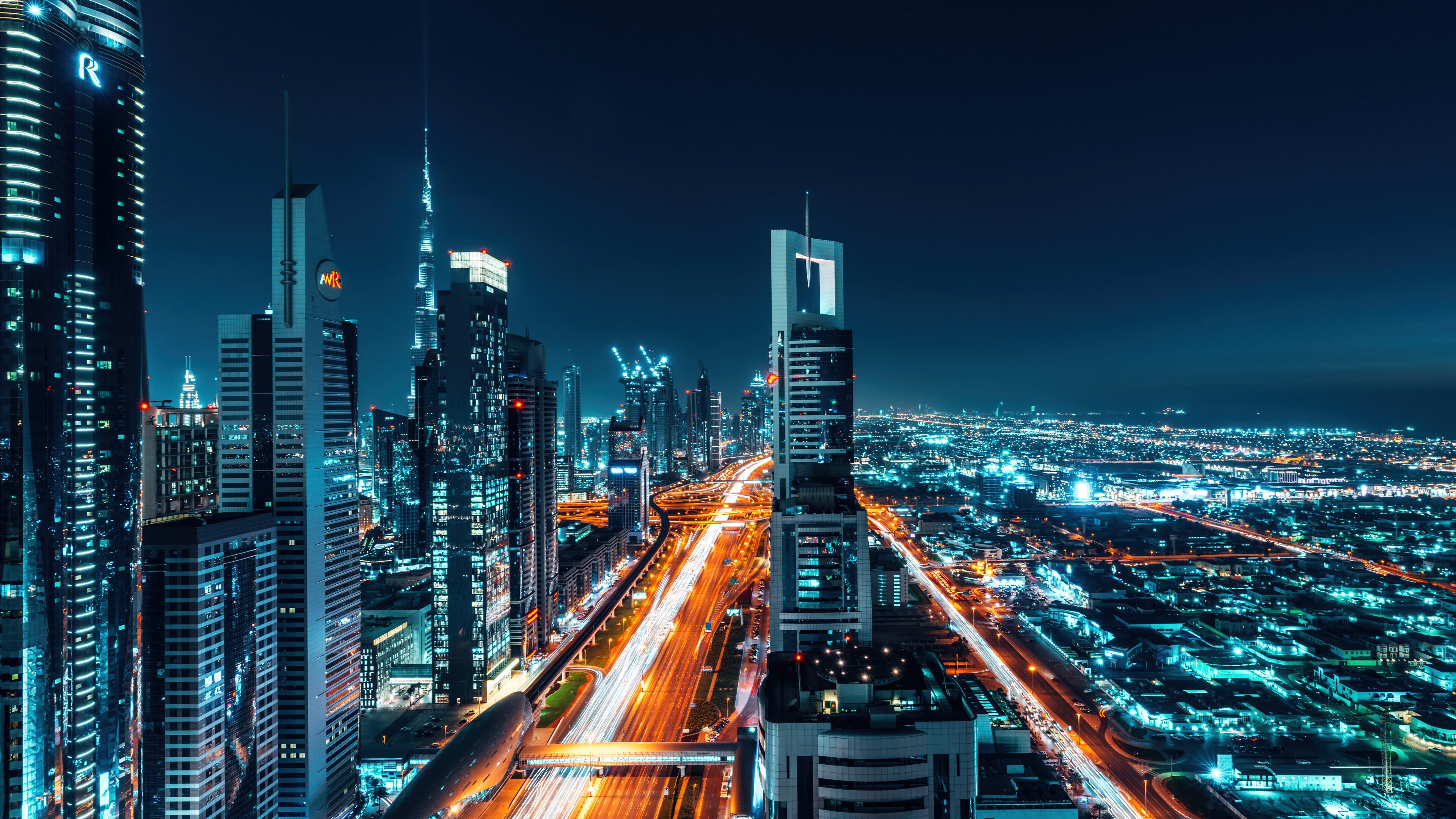 Cityscape at Night with Skyscrapers and Highway HD Wallpaper