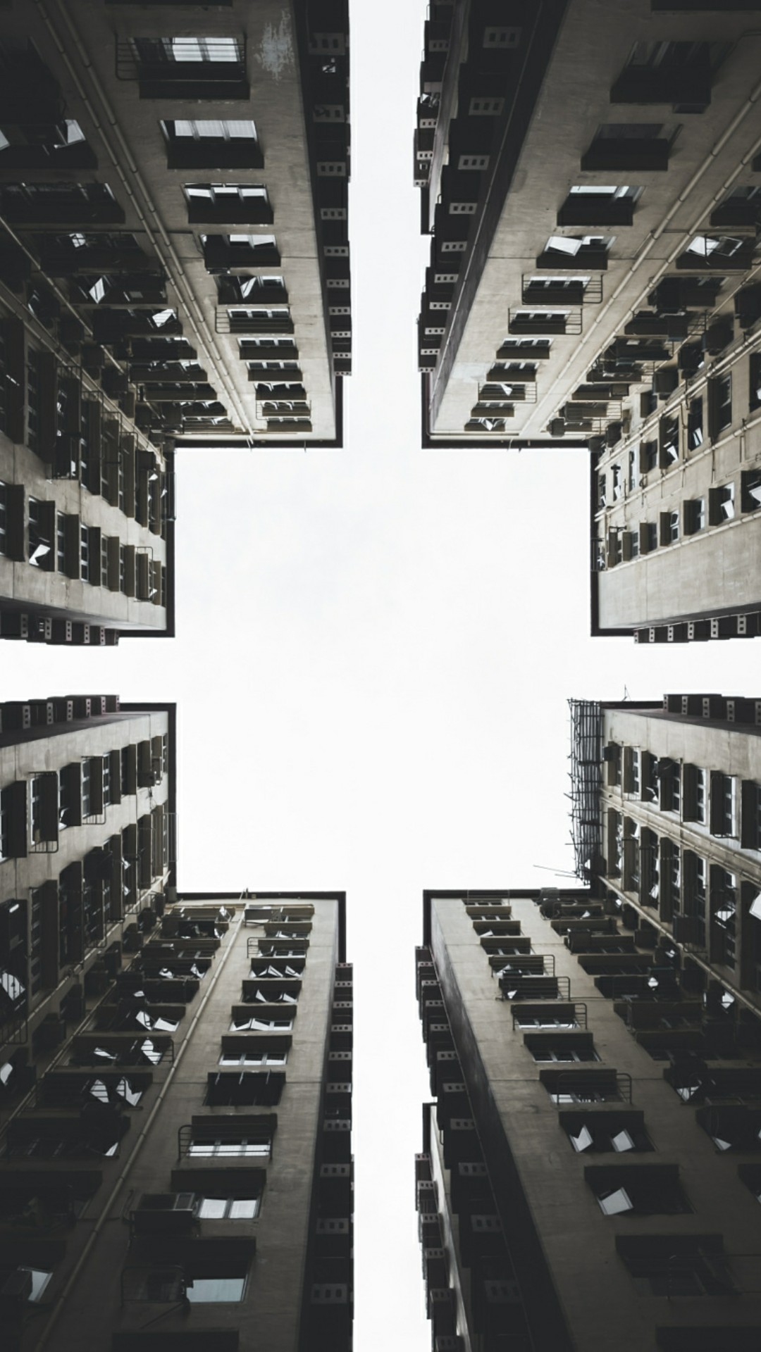 Looking up at apartment buildings forming a cross shape HD Wallpaper