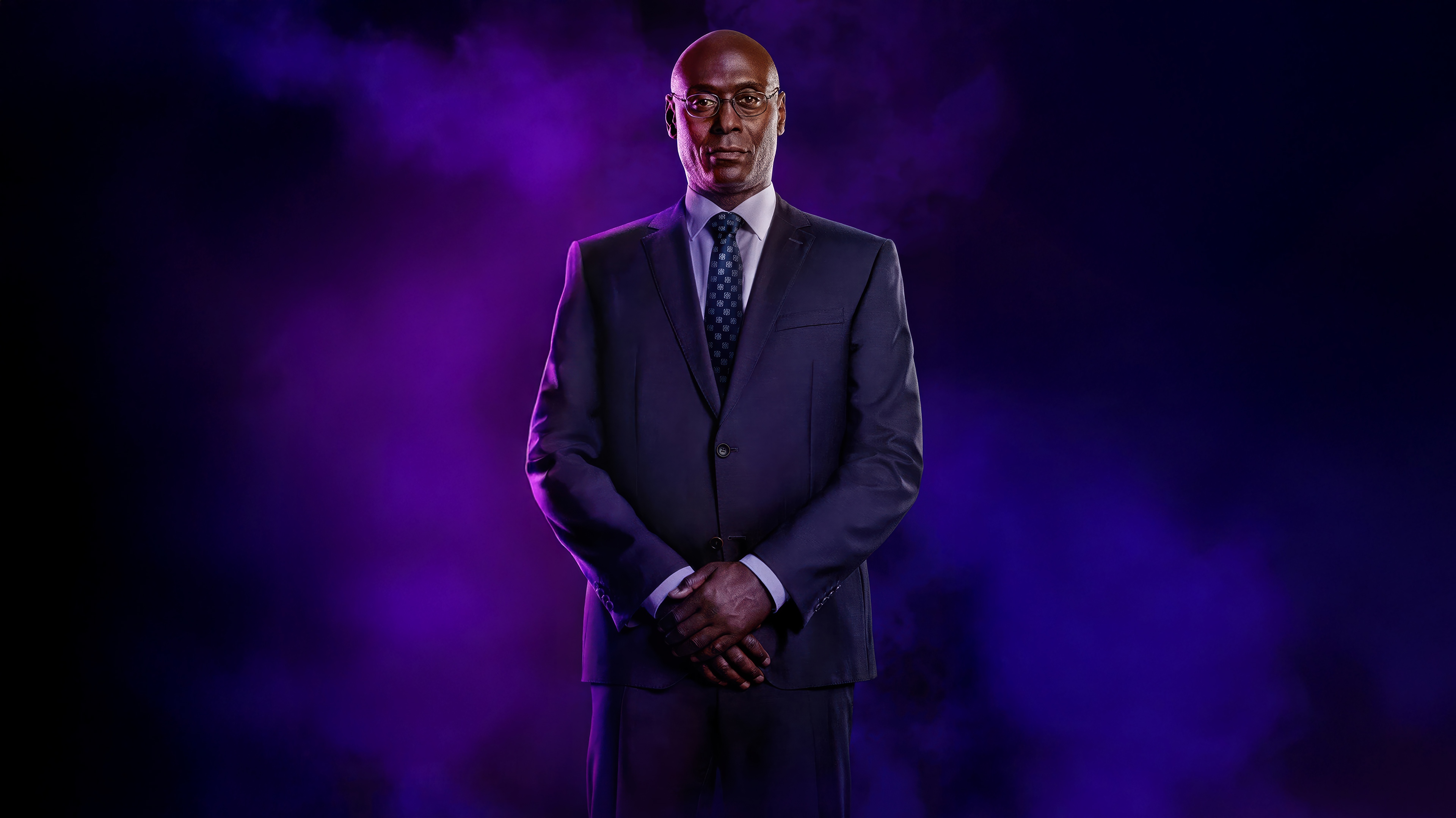 Lance Reddick in a suit with purple smoke HD Wallpaper