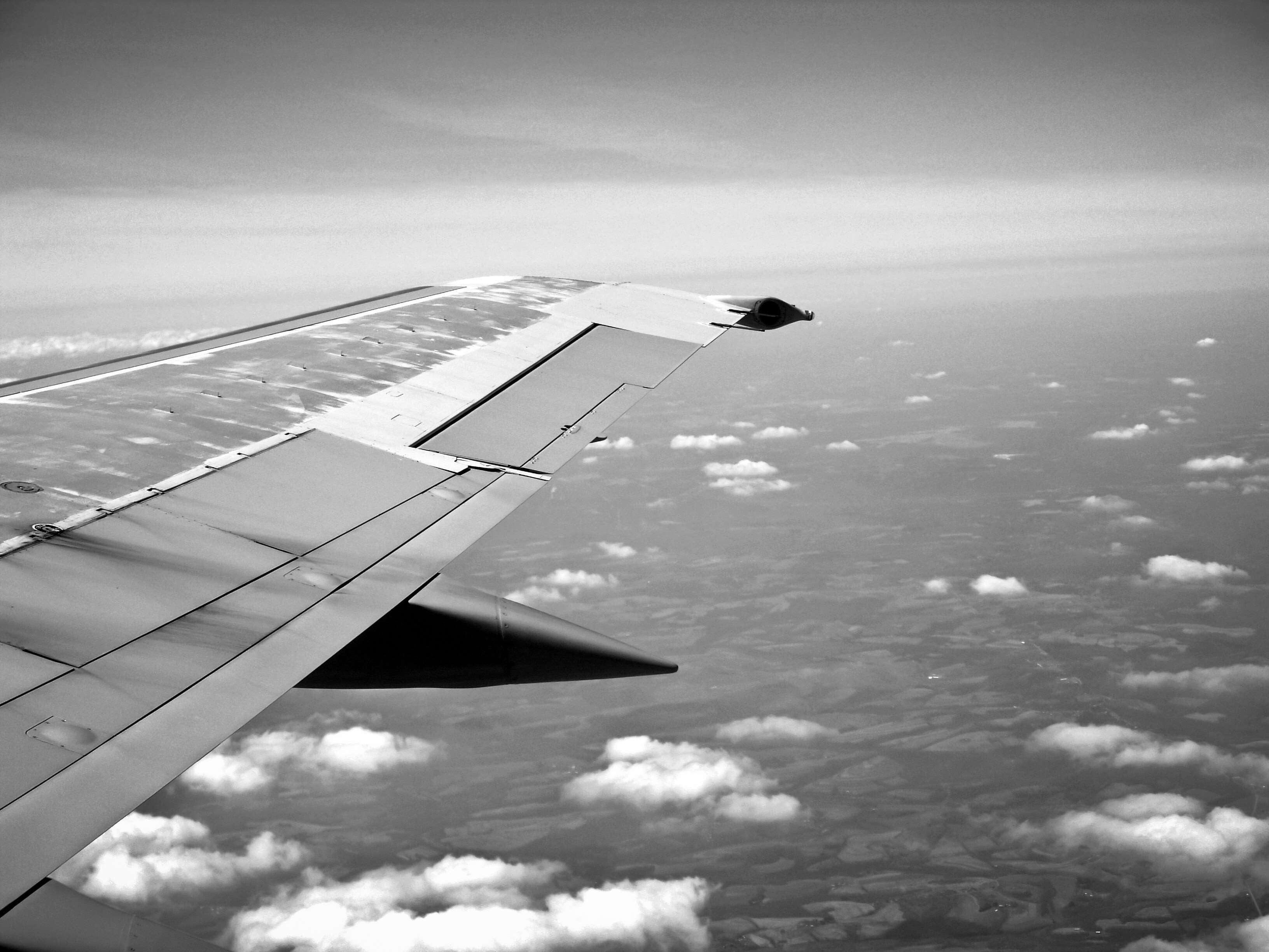 Airplane wing flying over clouds HD Wallpaper