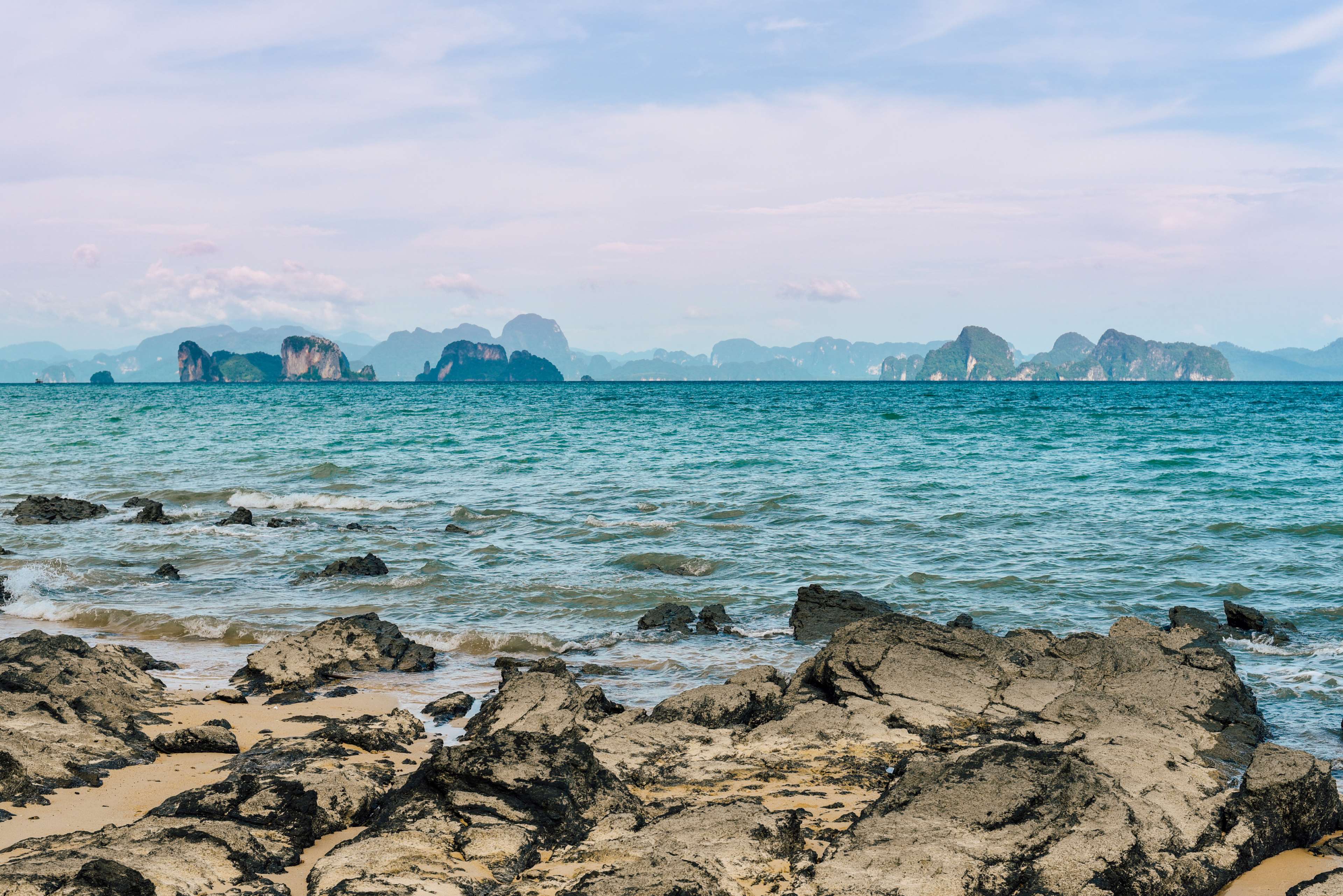 Rocky seashore with islands in the distance HD Wallpaper