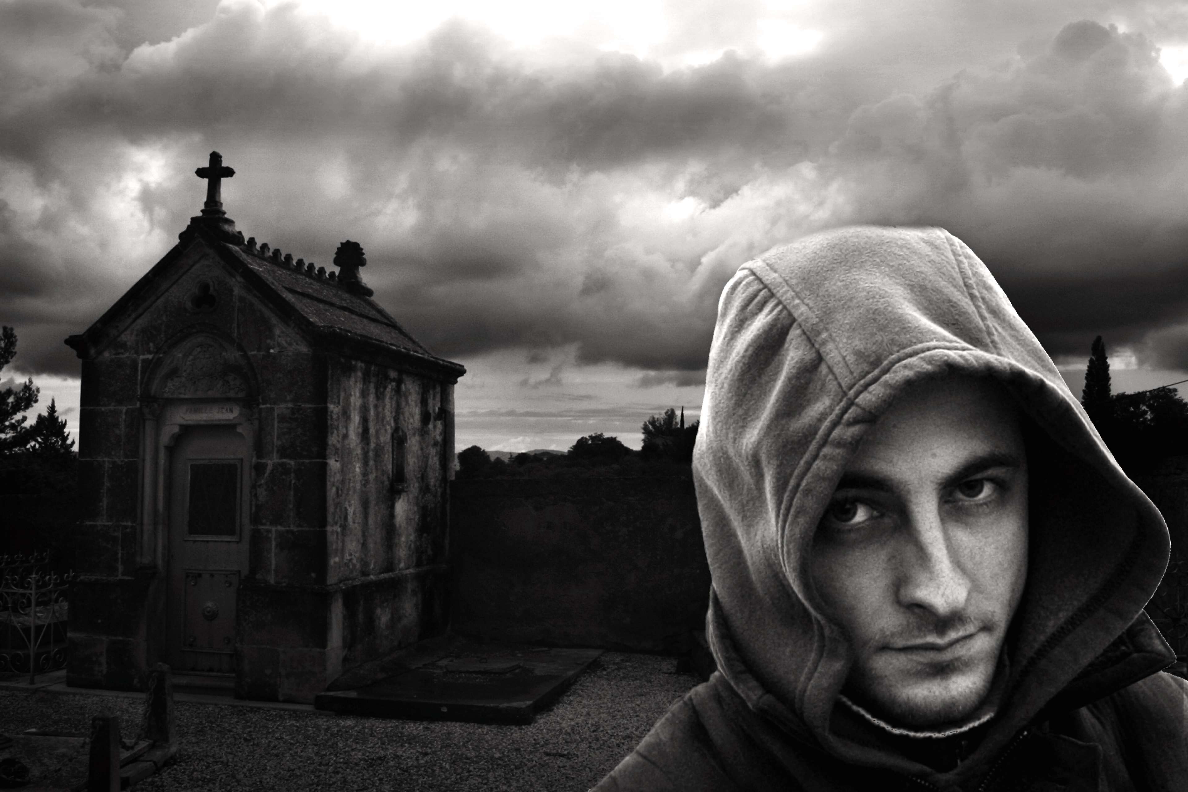 Man in Hood in Cemetery HD Wallpaper