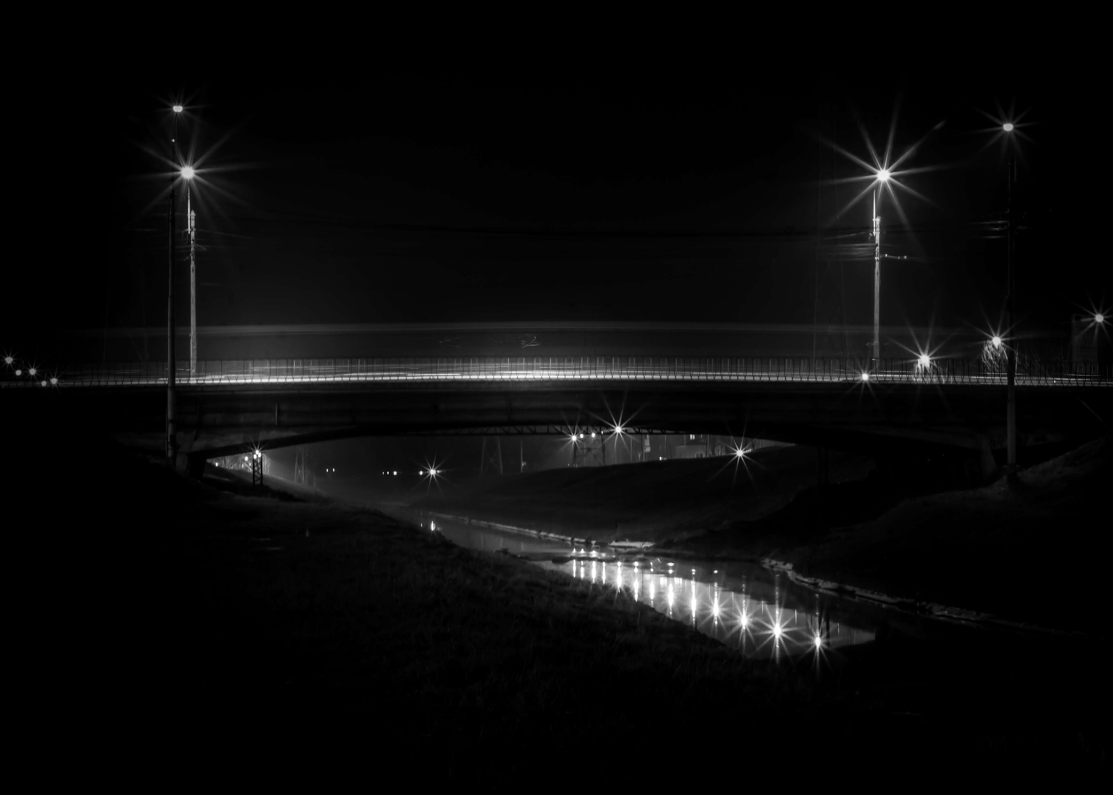 Long exposure night shot of a bridge over a river HD Wallpaper