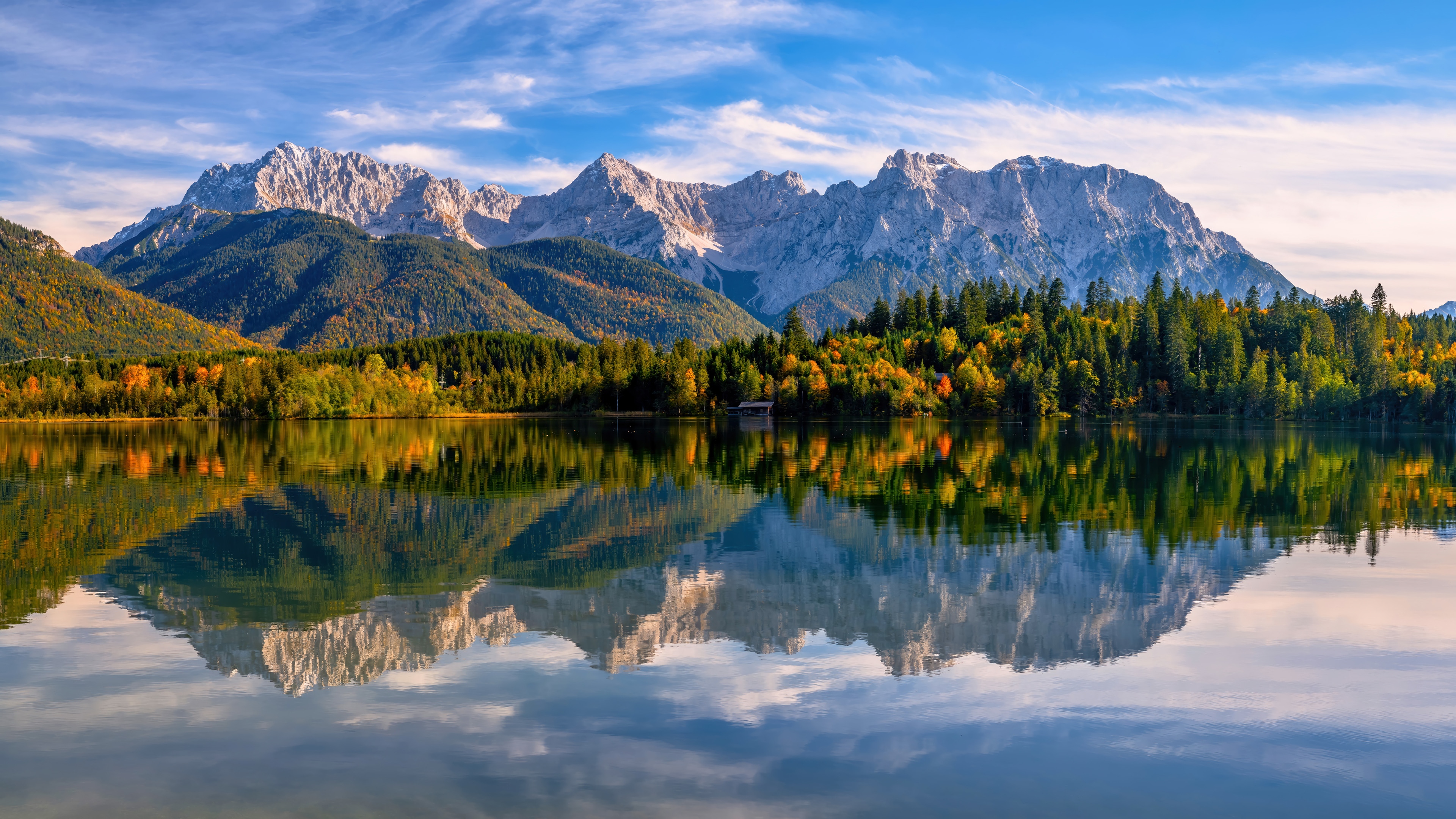 Mountain range reflected in a lake with autumn forest HD Wallpaper