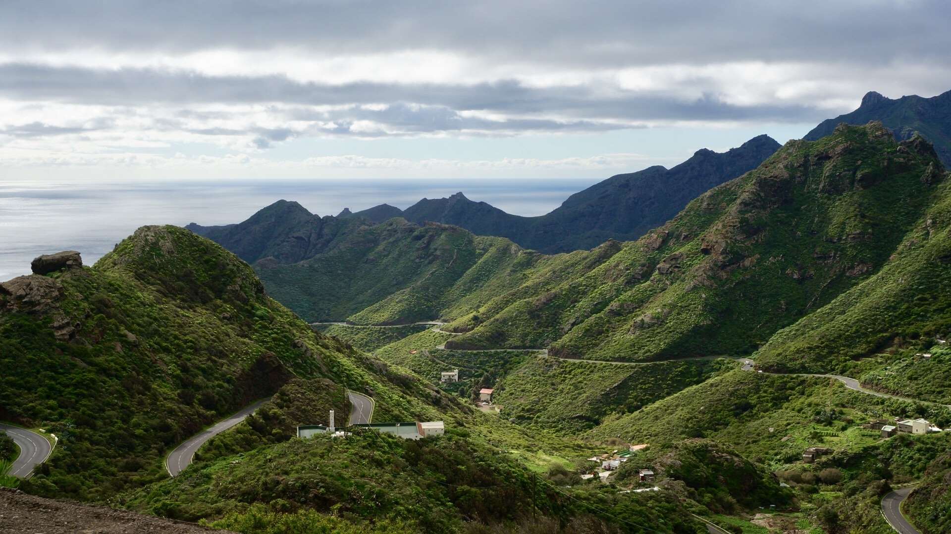 Road winding through green mountains in Tenerife, Canary Islands HD Wallpaper