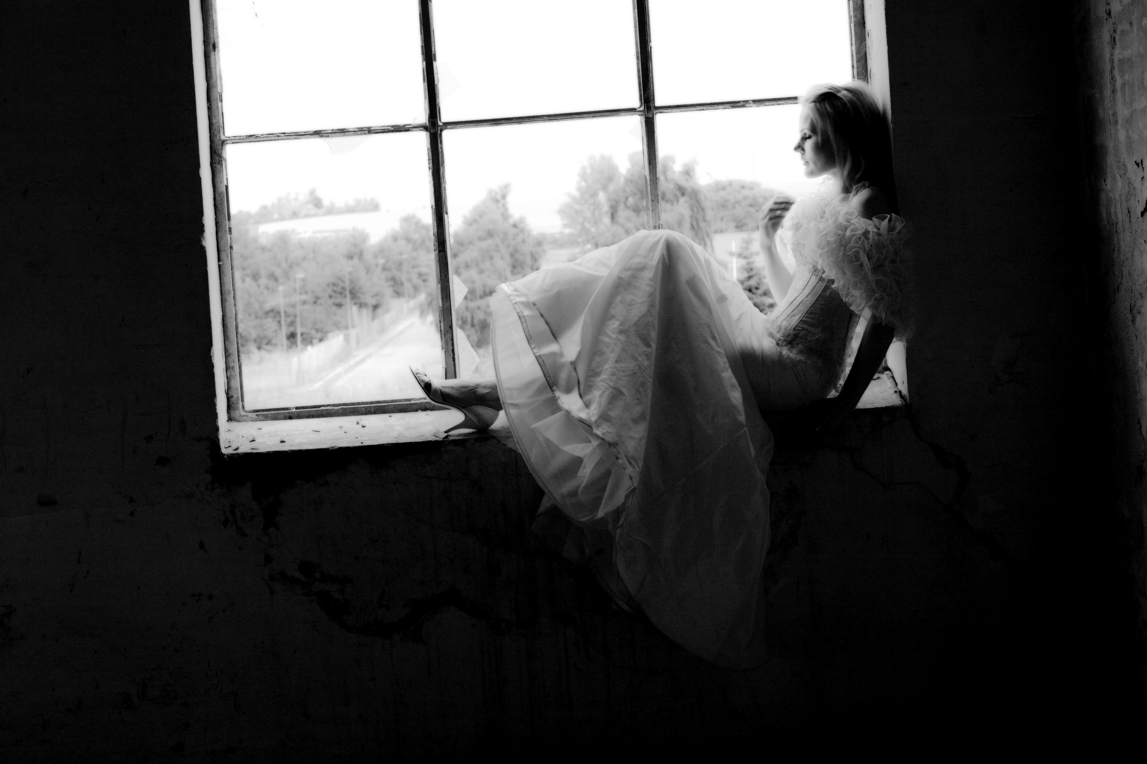 Woman in white dress sitting by a window HD Wallpaper